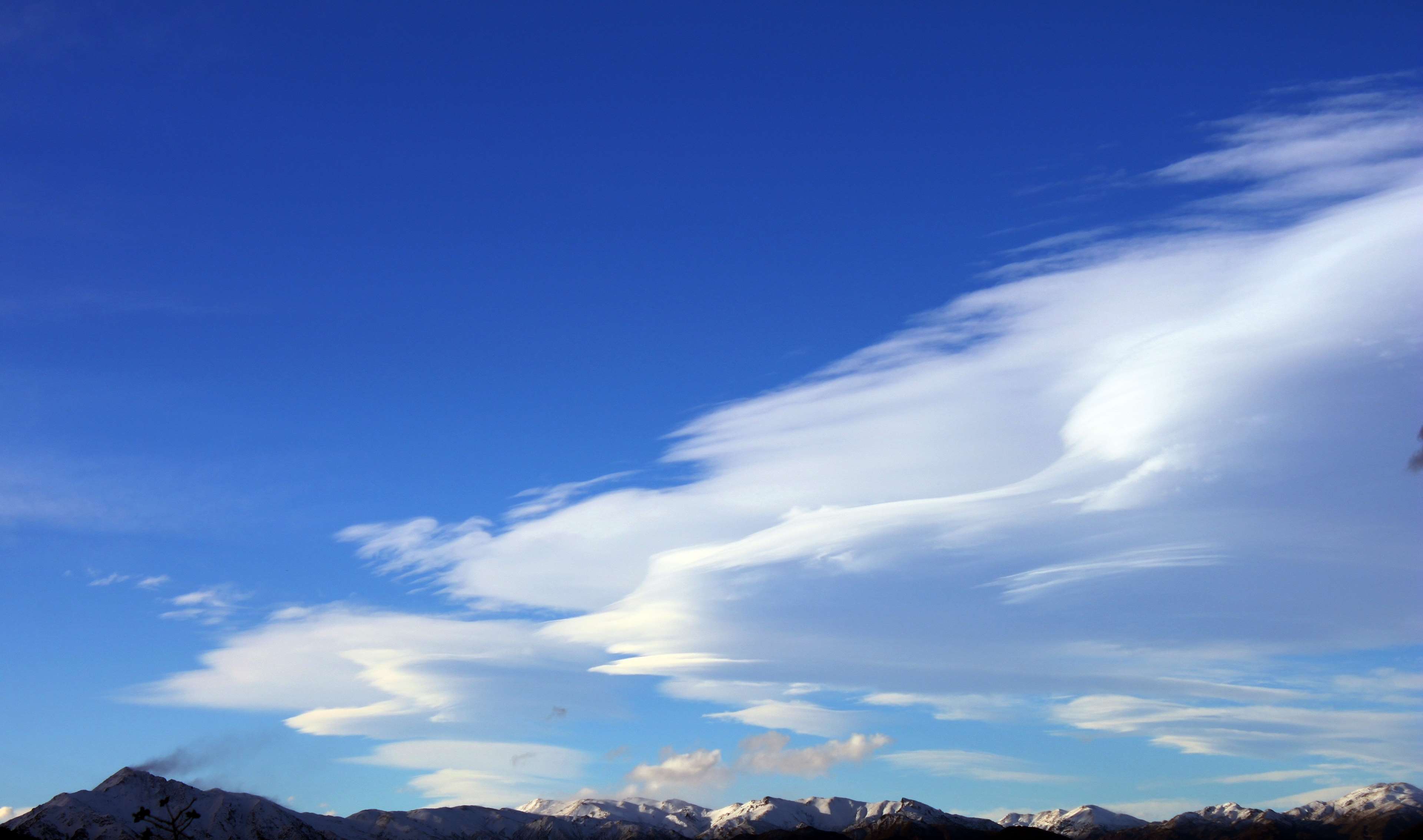 Mountains under a blue sky with clouds HD Wallpaper