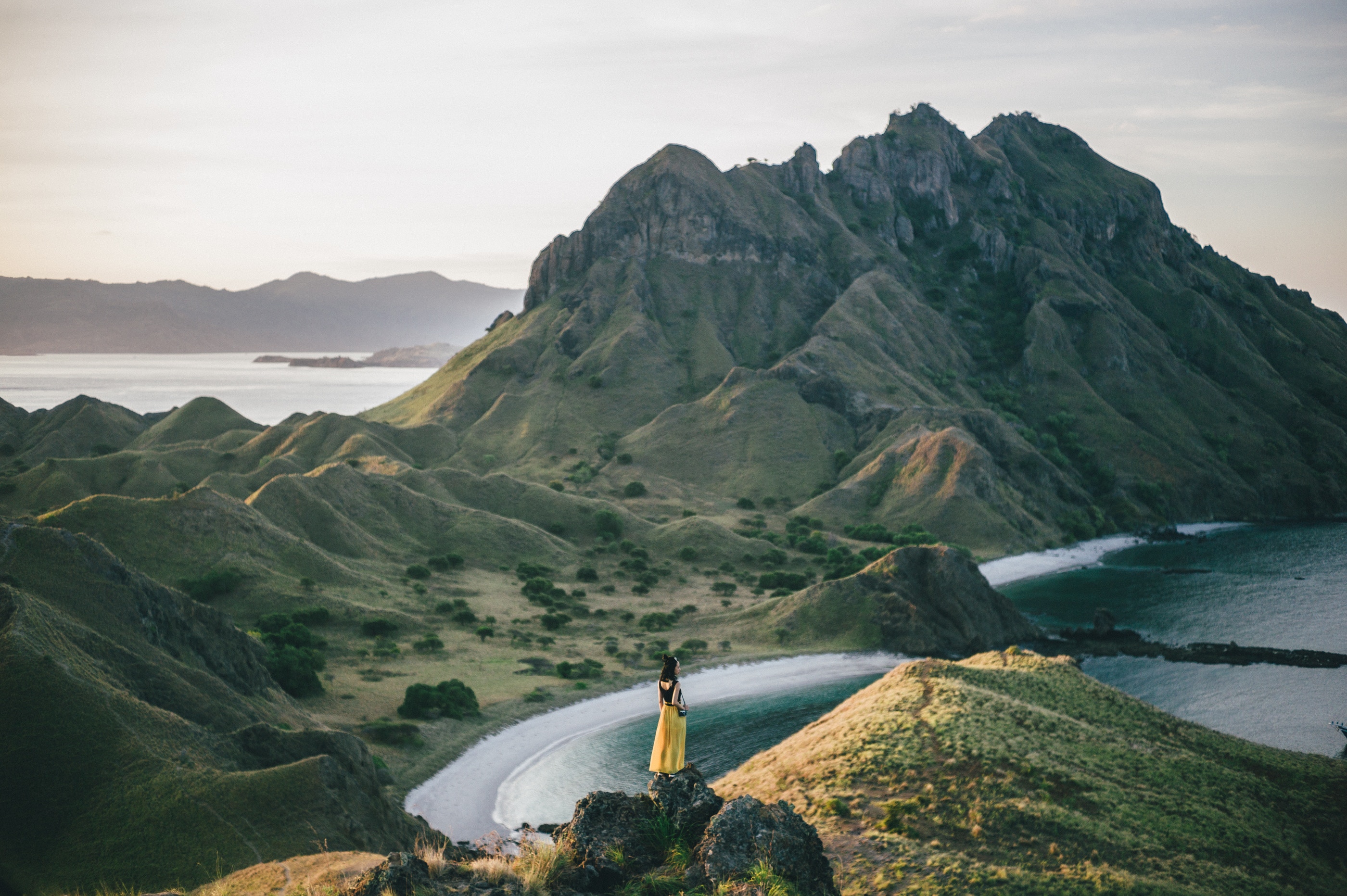 Woman in yellow dress on Padar Island, Indonesia HD Wallpaper