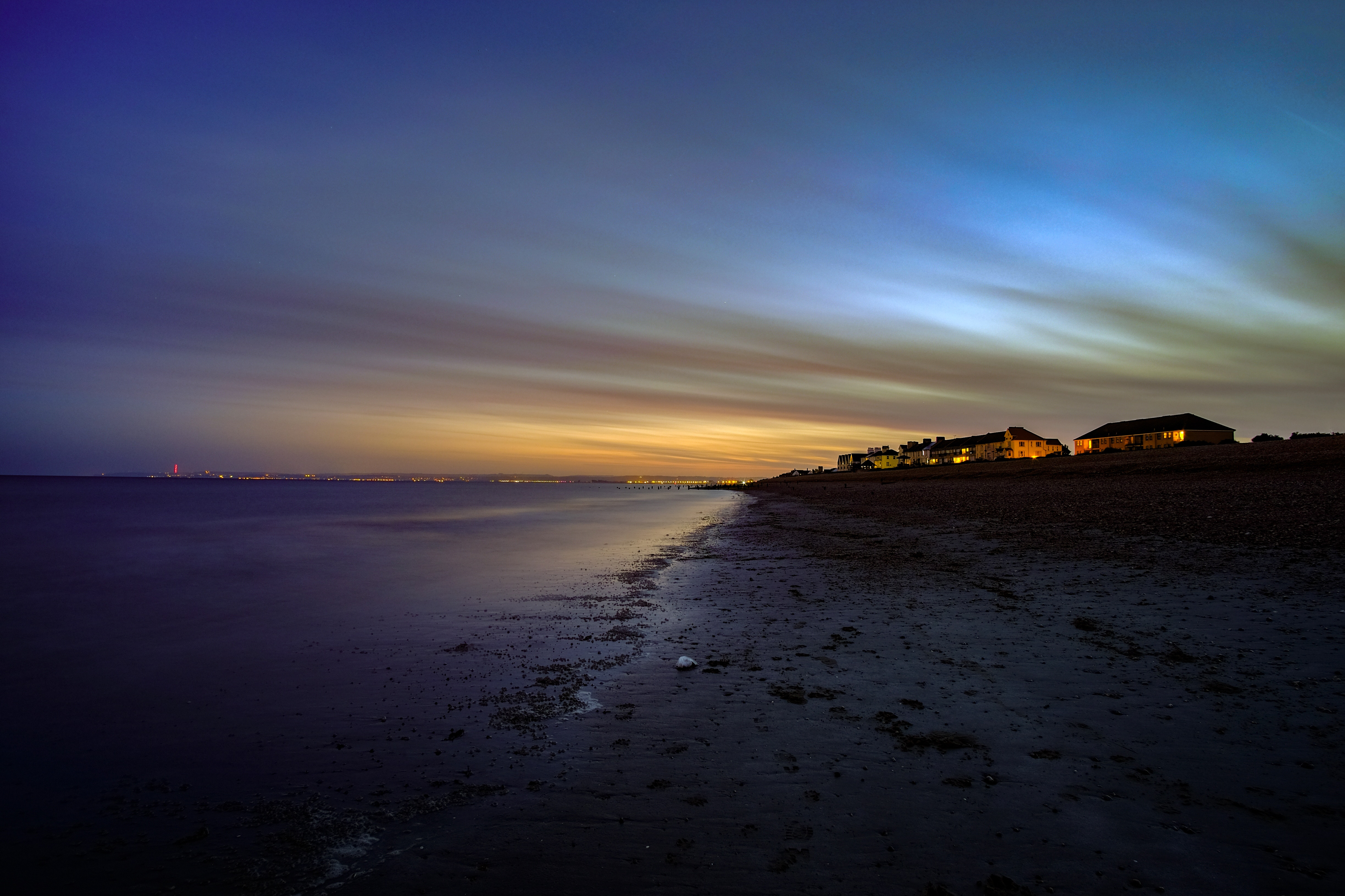 Long exposure of a beach at twilight with houses HD Wallpaper