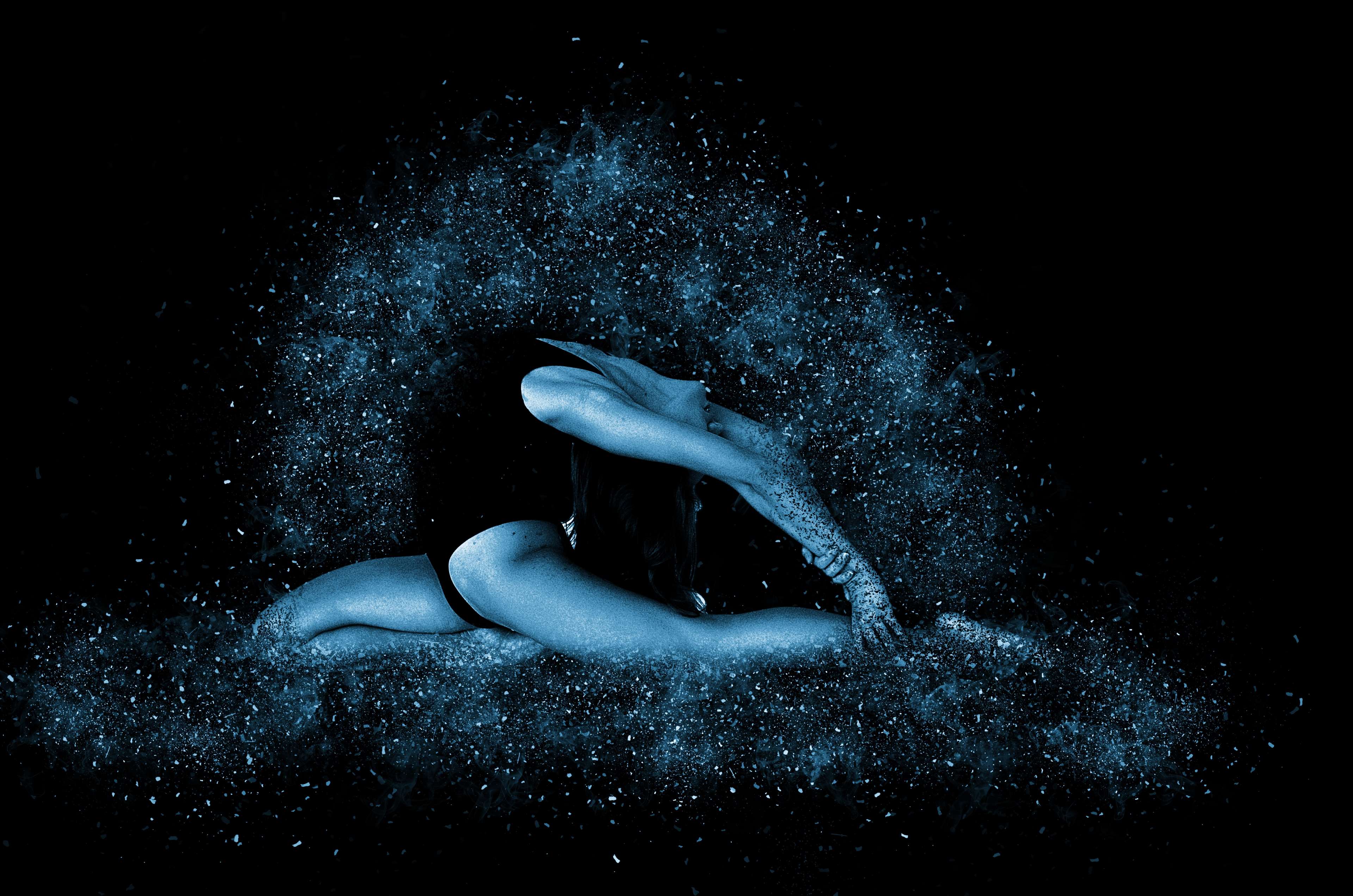 Woman in elegant gymnastics pose with blue particles HD Wallpaper