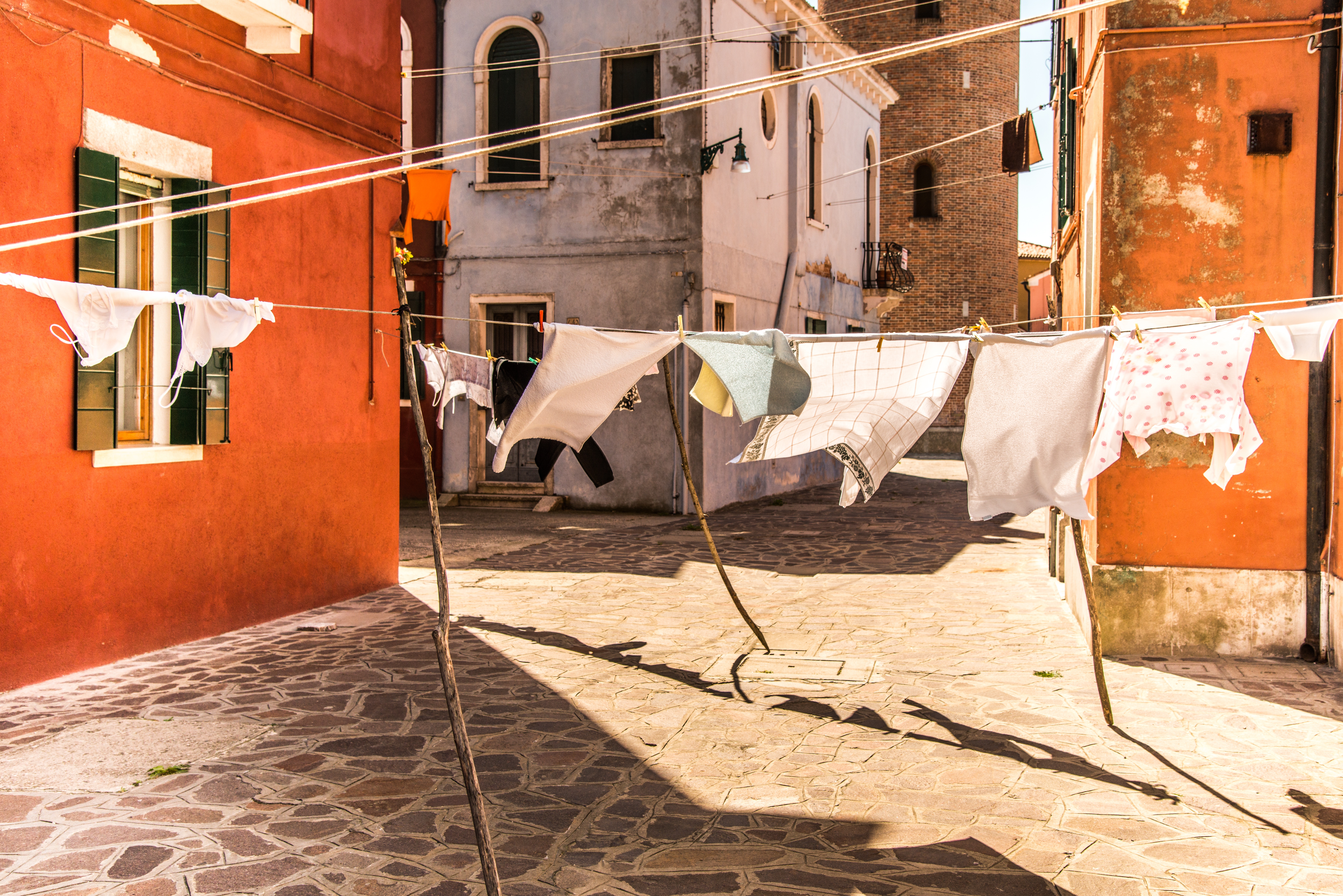 Clothes drying on a line in a colorful village HD Wallpaper
