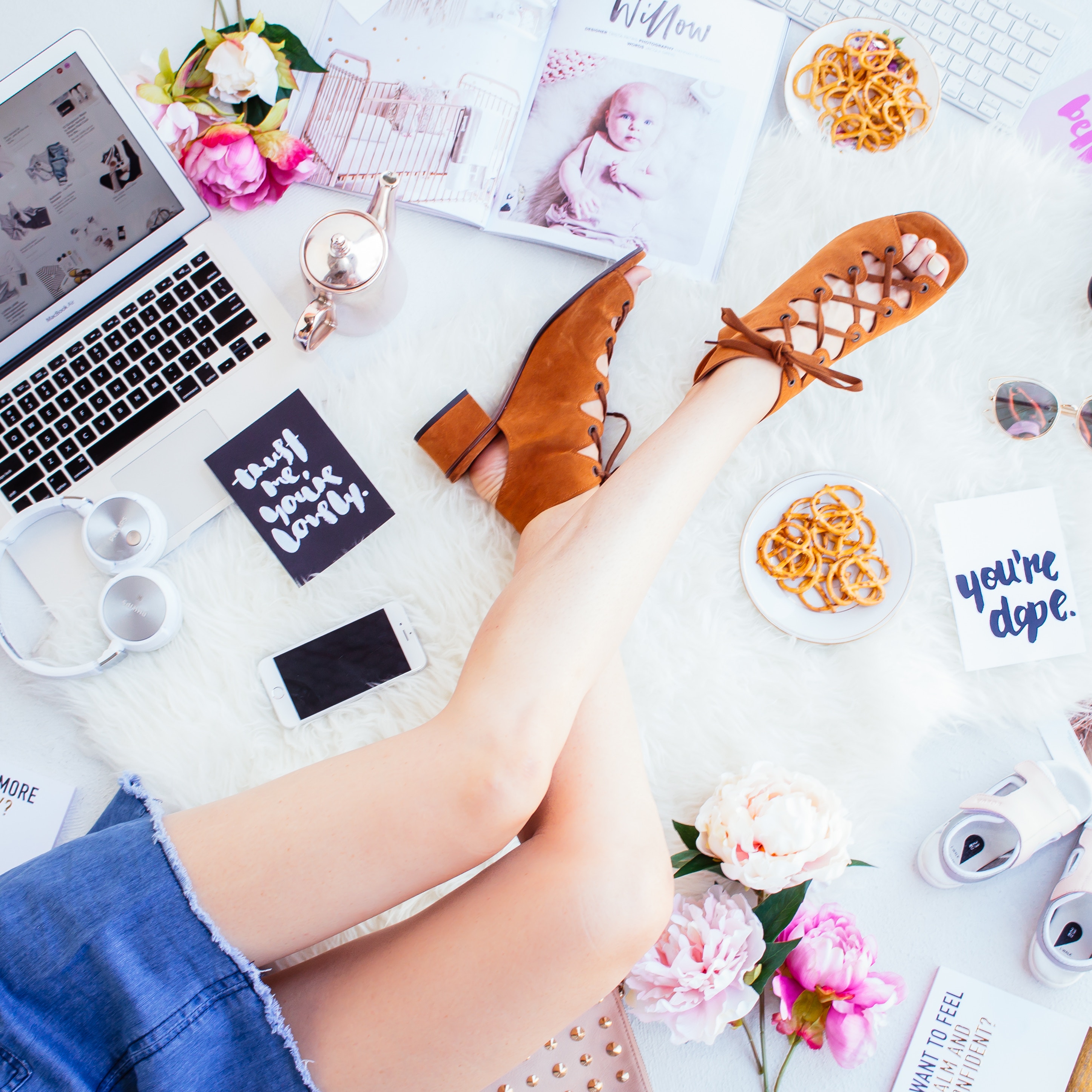 Flat lay of a woman's legs with laptop, shoes, and snacks HD Wallpaper