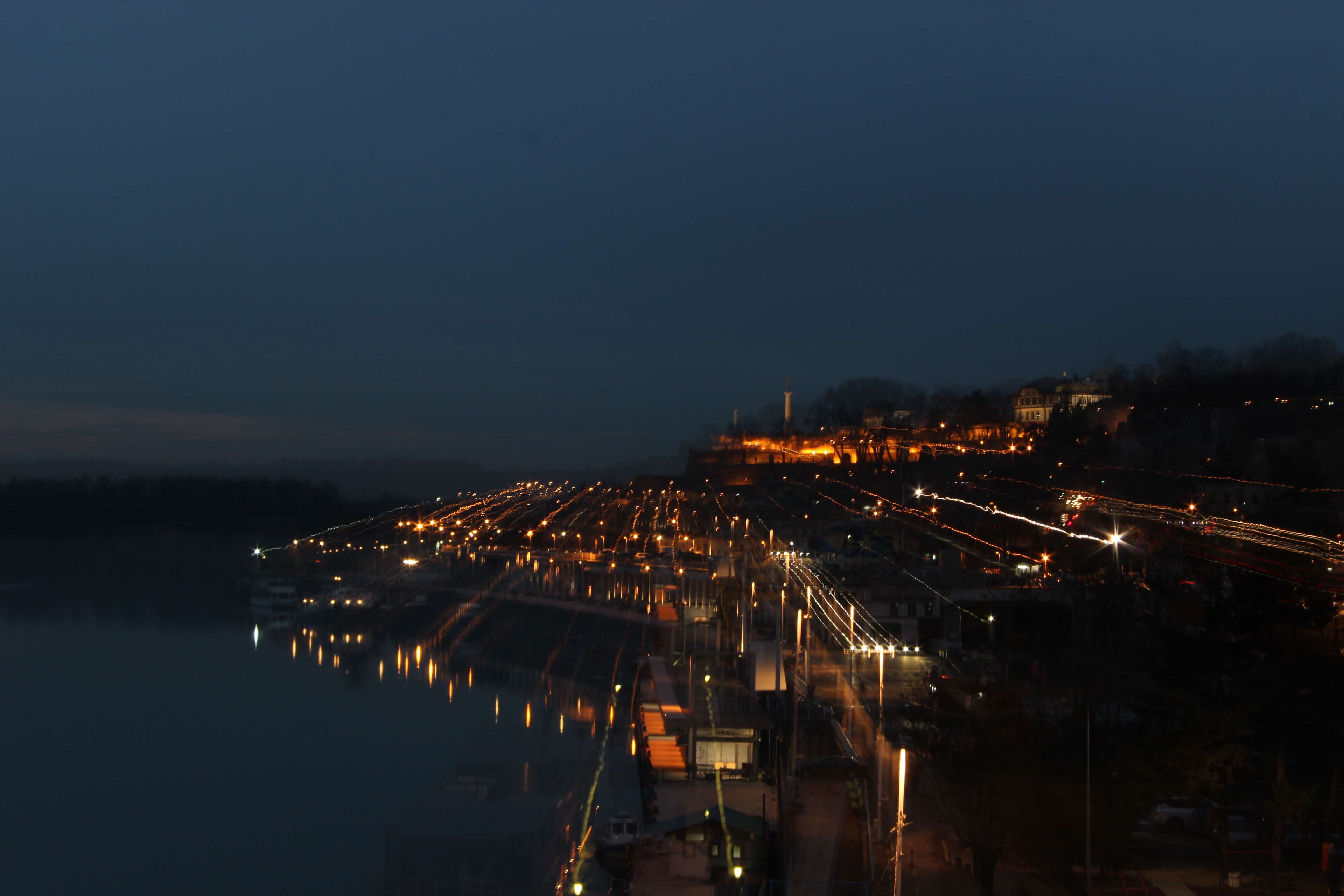 City lights at night along a river HD Wallpaper