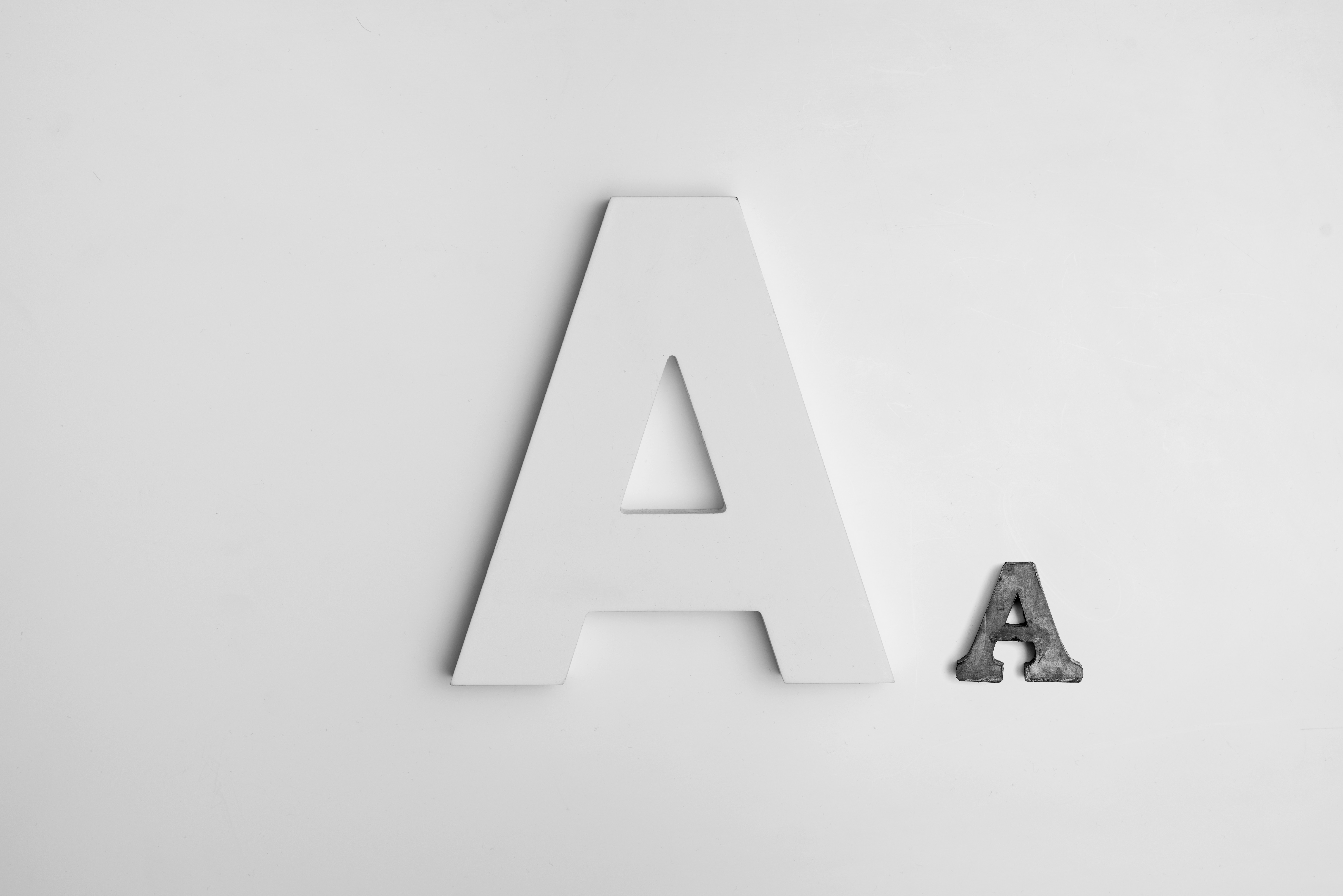 Two letter A's, one large white and one small metal HD Wallpaper