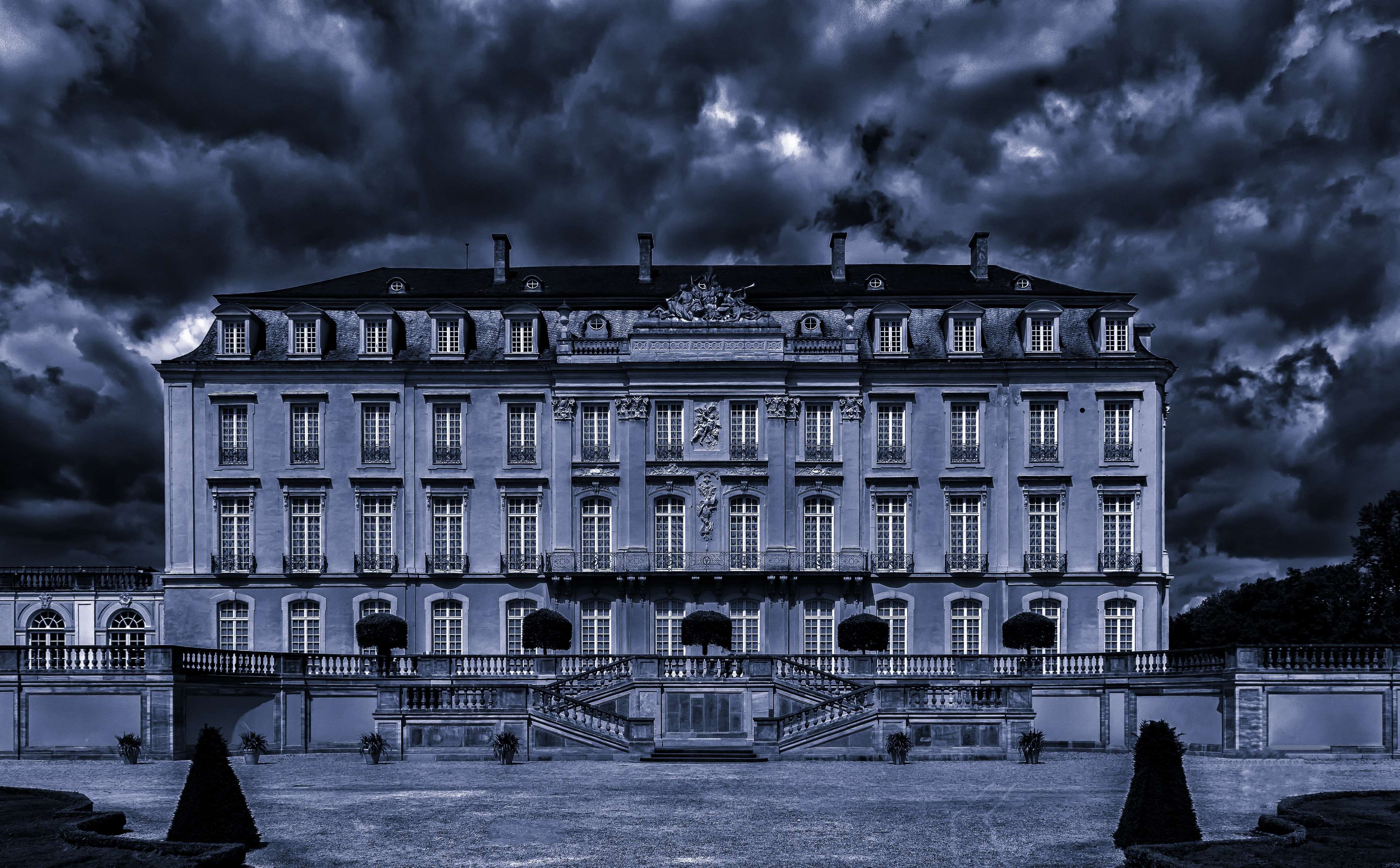 Baroque mansion facade with dark stormy clouds HD Wallpaper