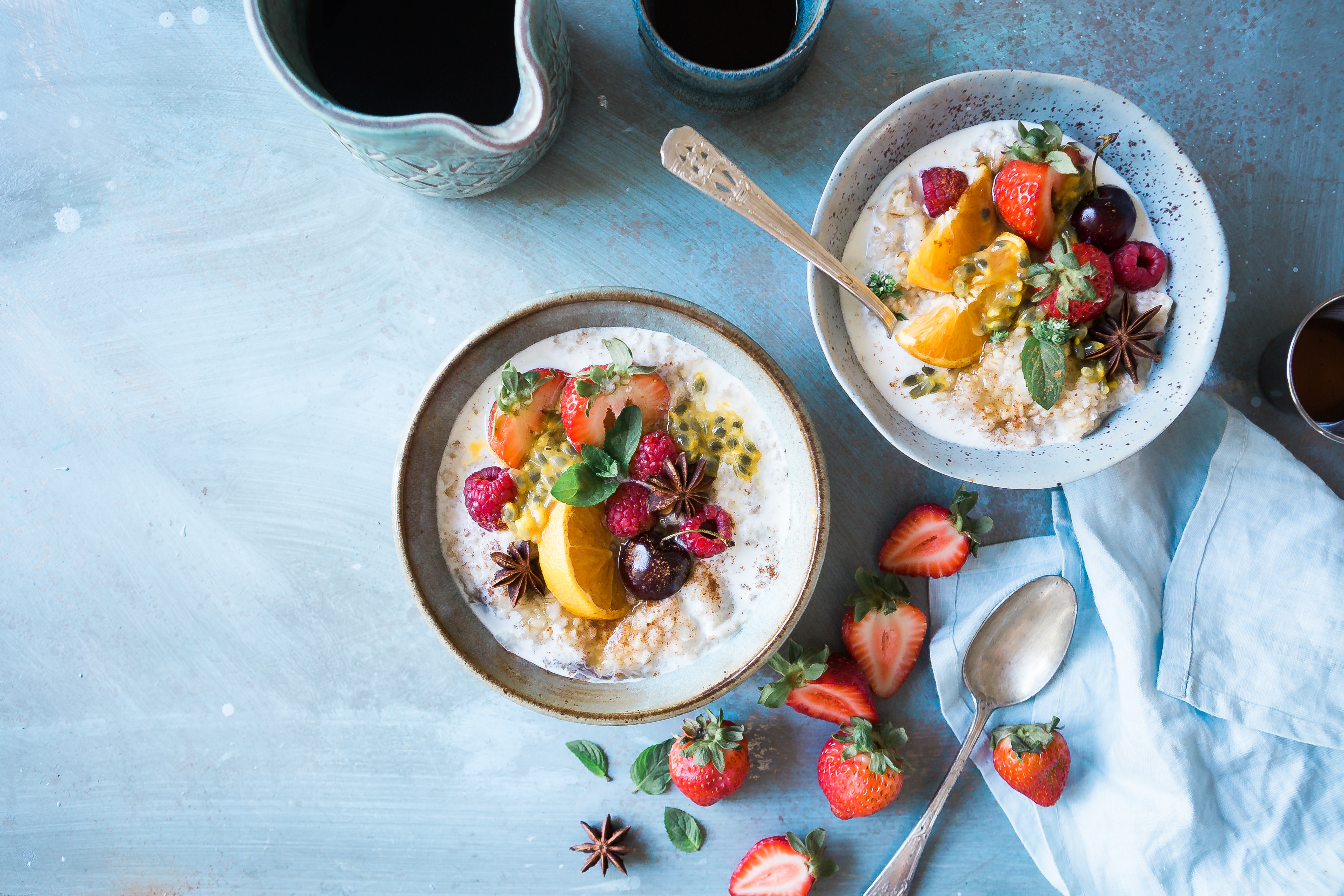 Two bowls of oatmeal with fruits and coffee HD Wallpaper