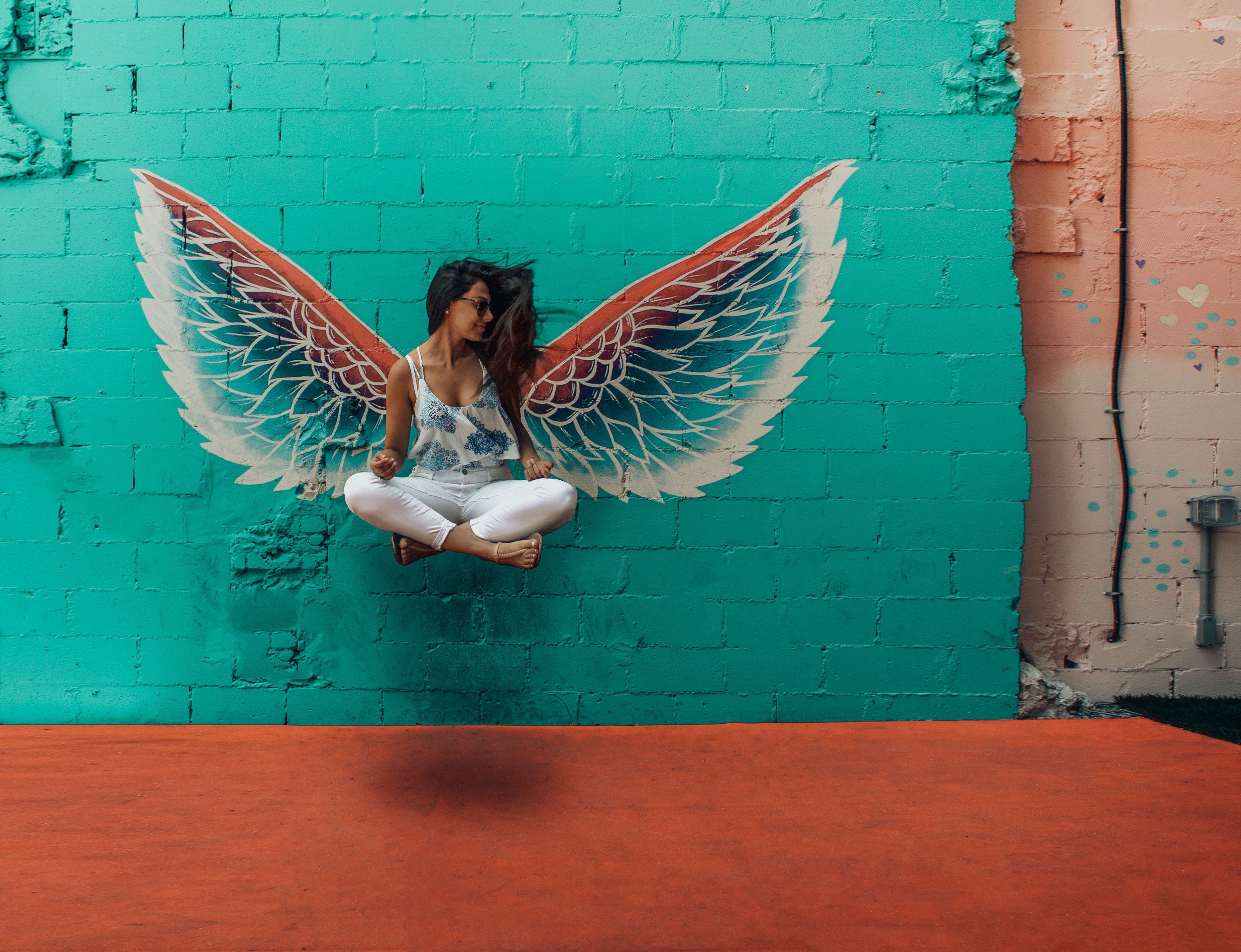 Woman Levitating with Angel Wings on Colorful Wall HD Wallpaper