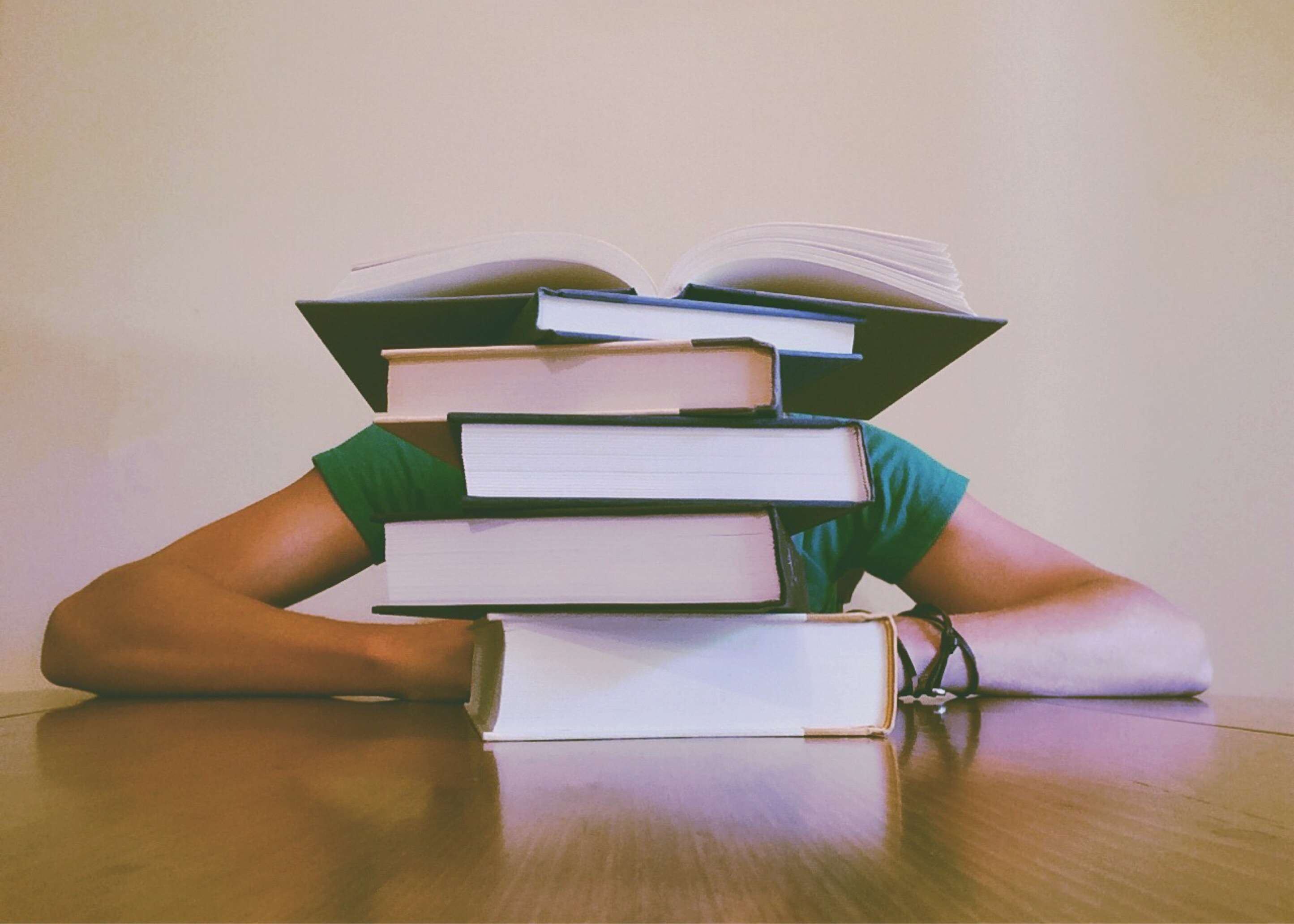 Person with stack of books on head HD Wallpaper