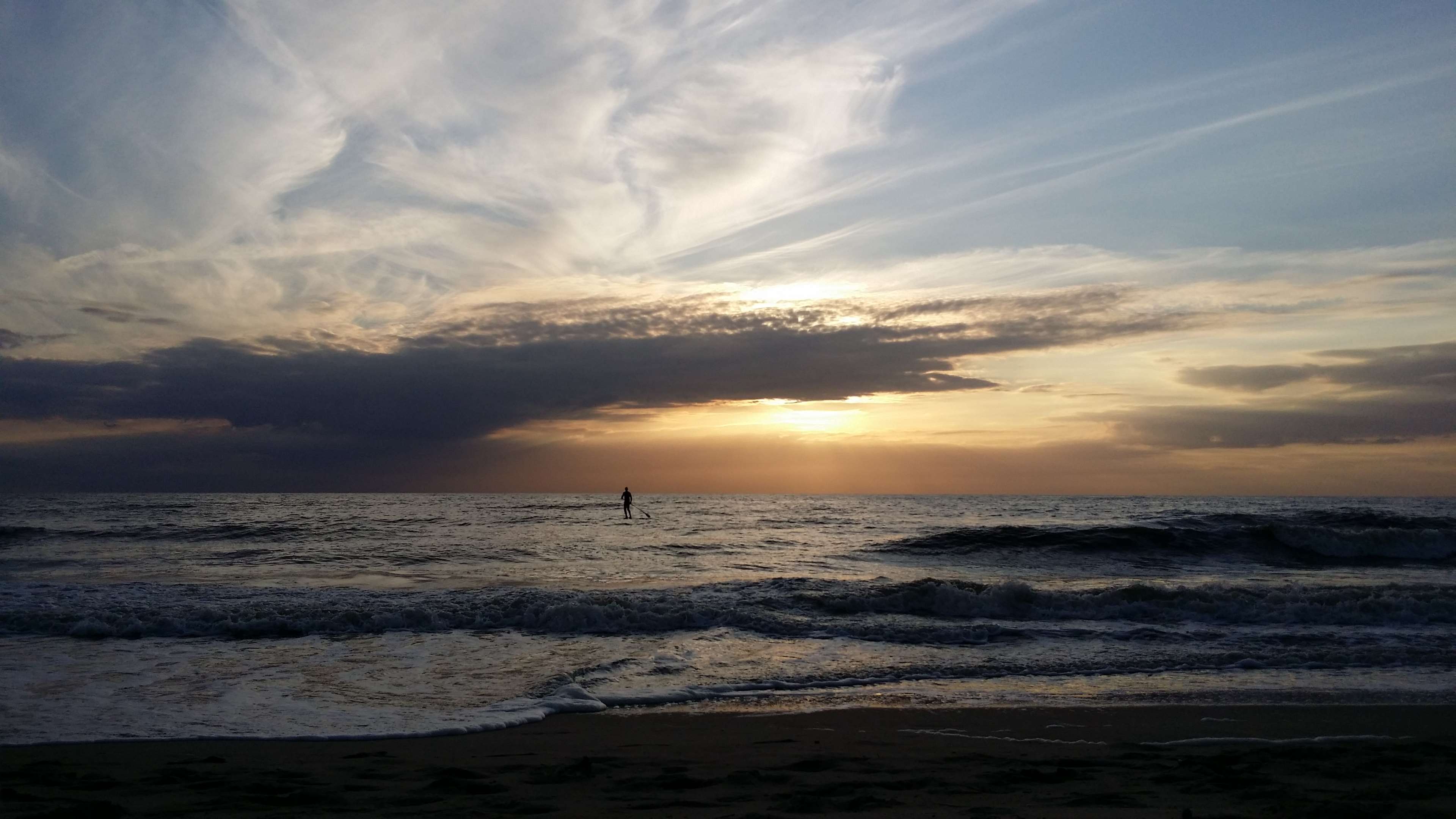 Sunset over the ocean with a surfer HD Wallpaper