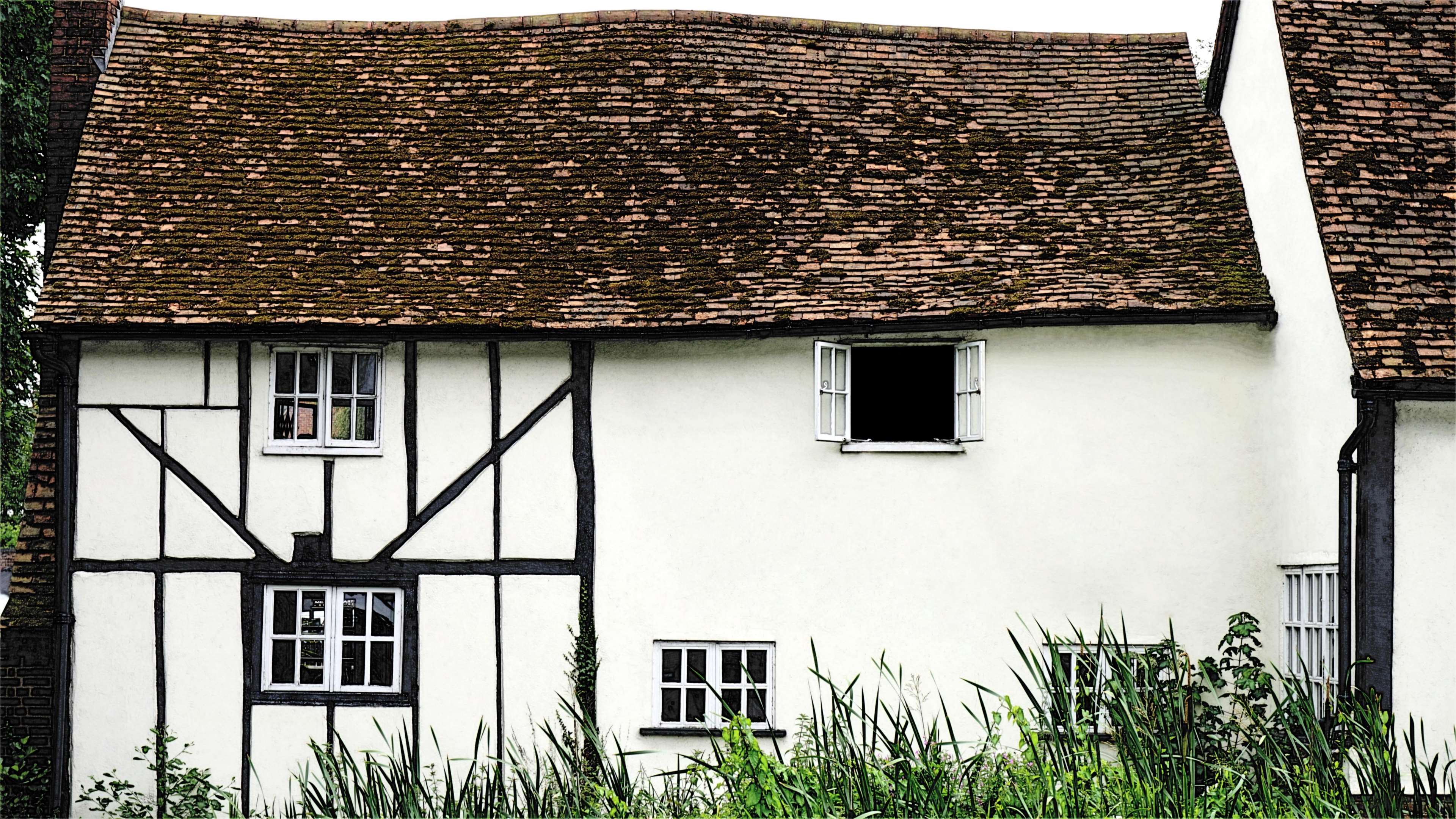 Tudor style house with tiled roof and white walls HD Wallpaper