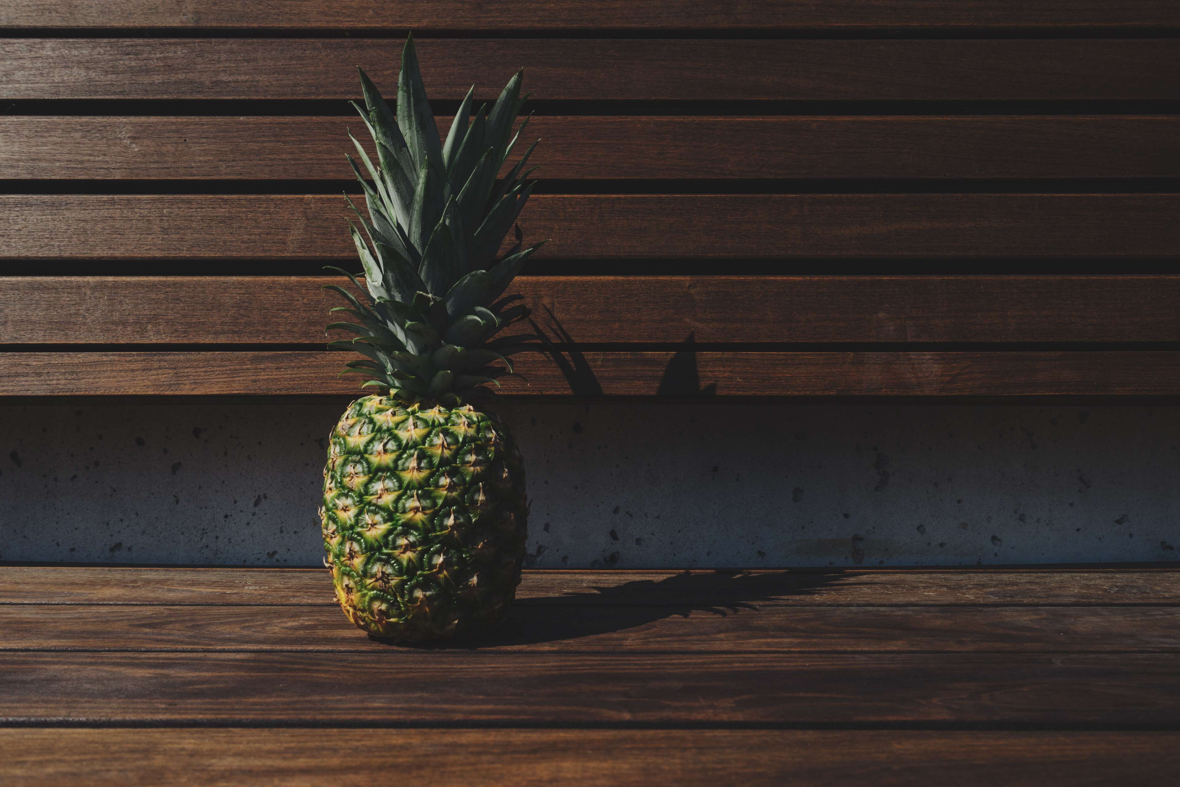 Pineapple on a wooden bench HD Wallpaper