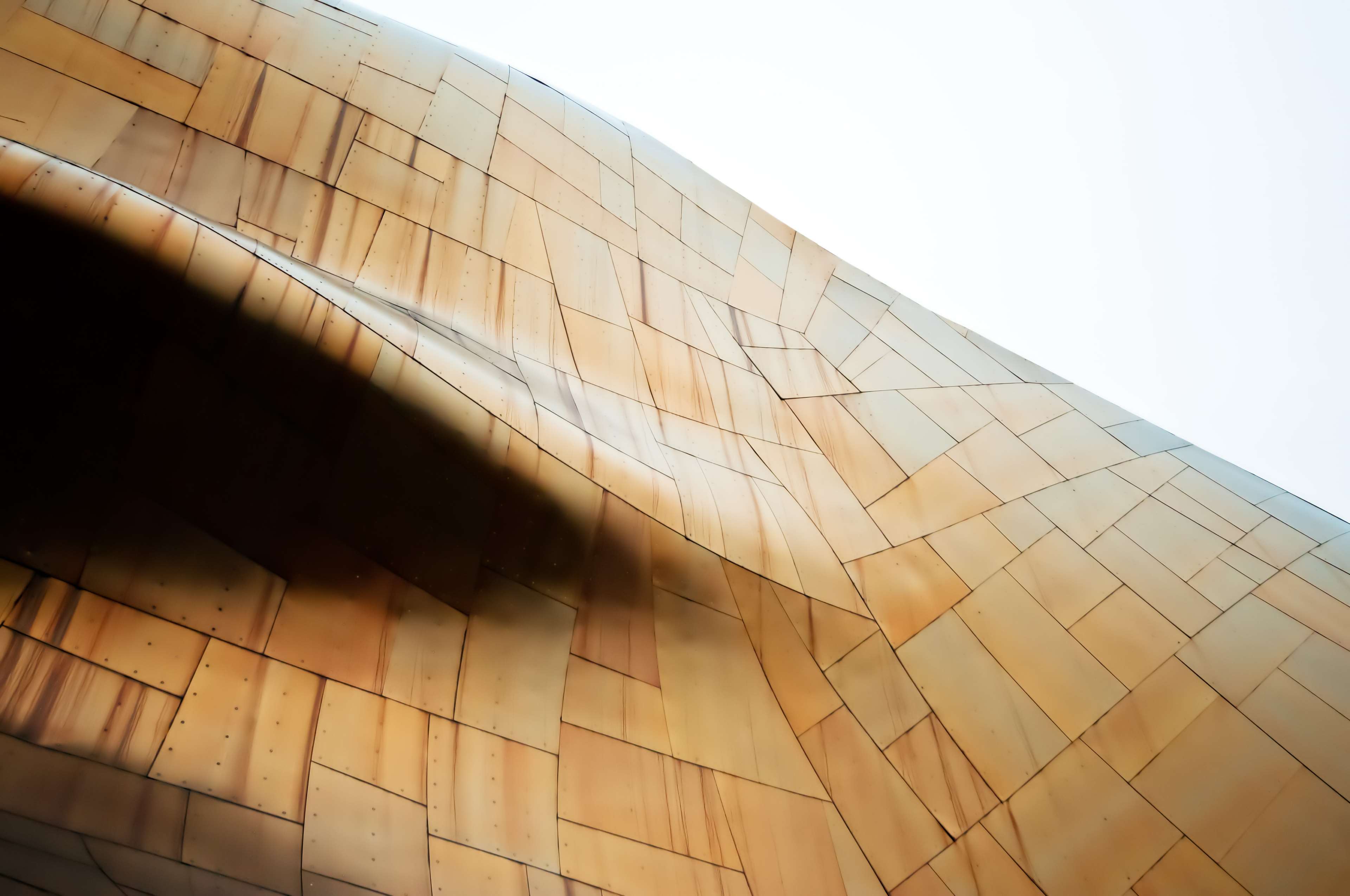Abstract architectural detail with bronze panels and shadow HD Wallpaper