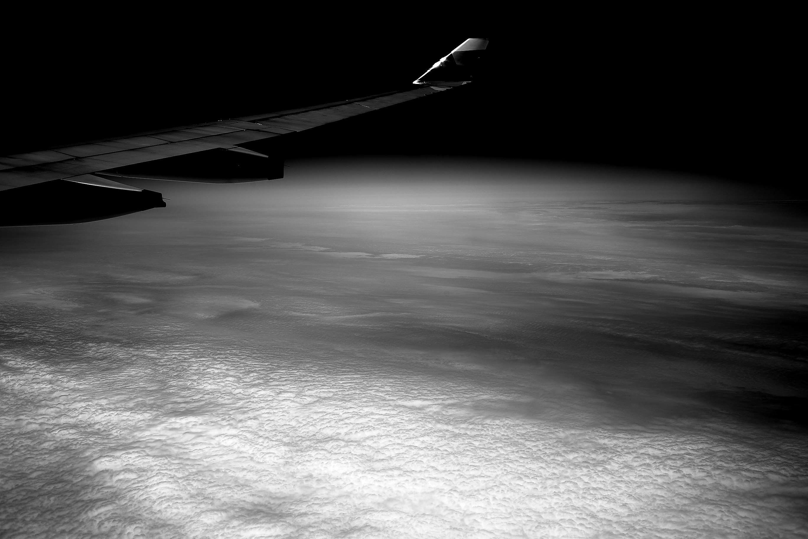 Airplane wing over clouds at night HD Wallpaper