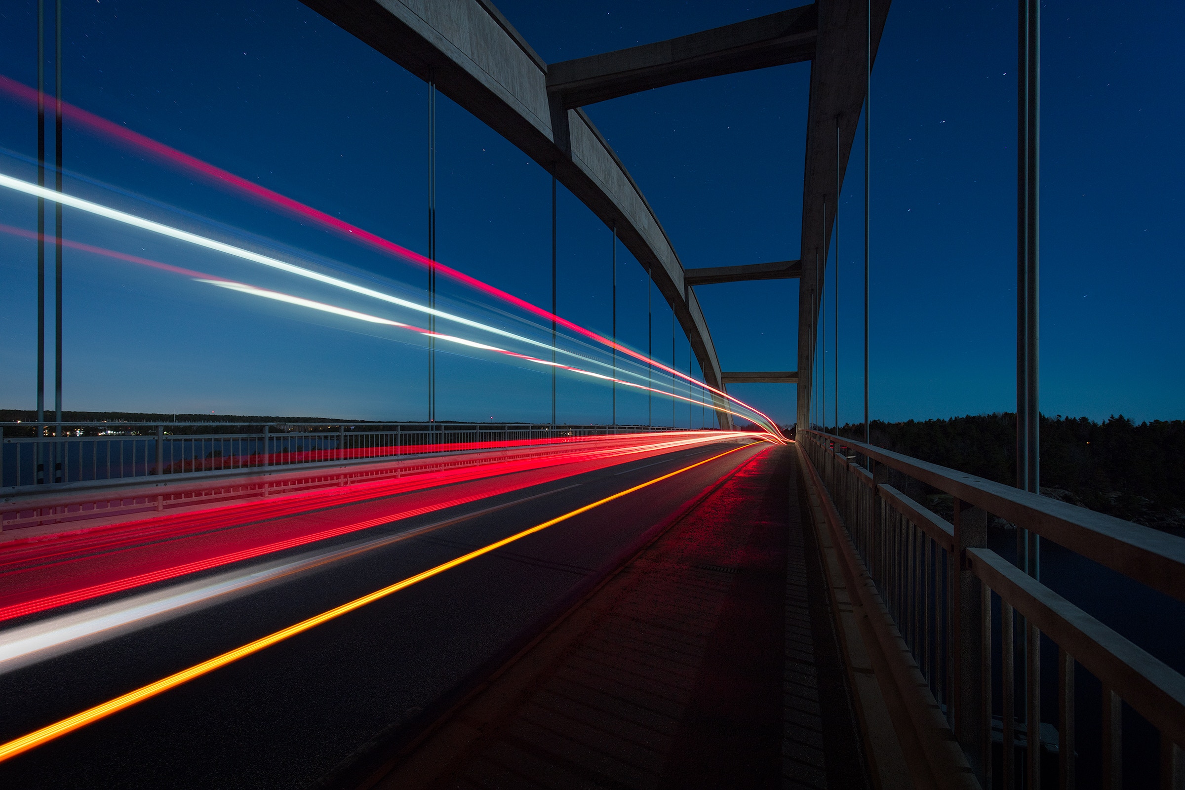 Long exposure of light trails on a bridge at night HD Wallpaper