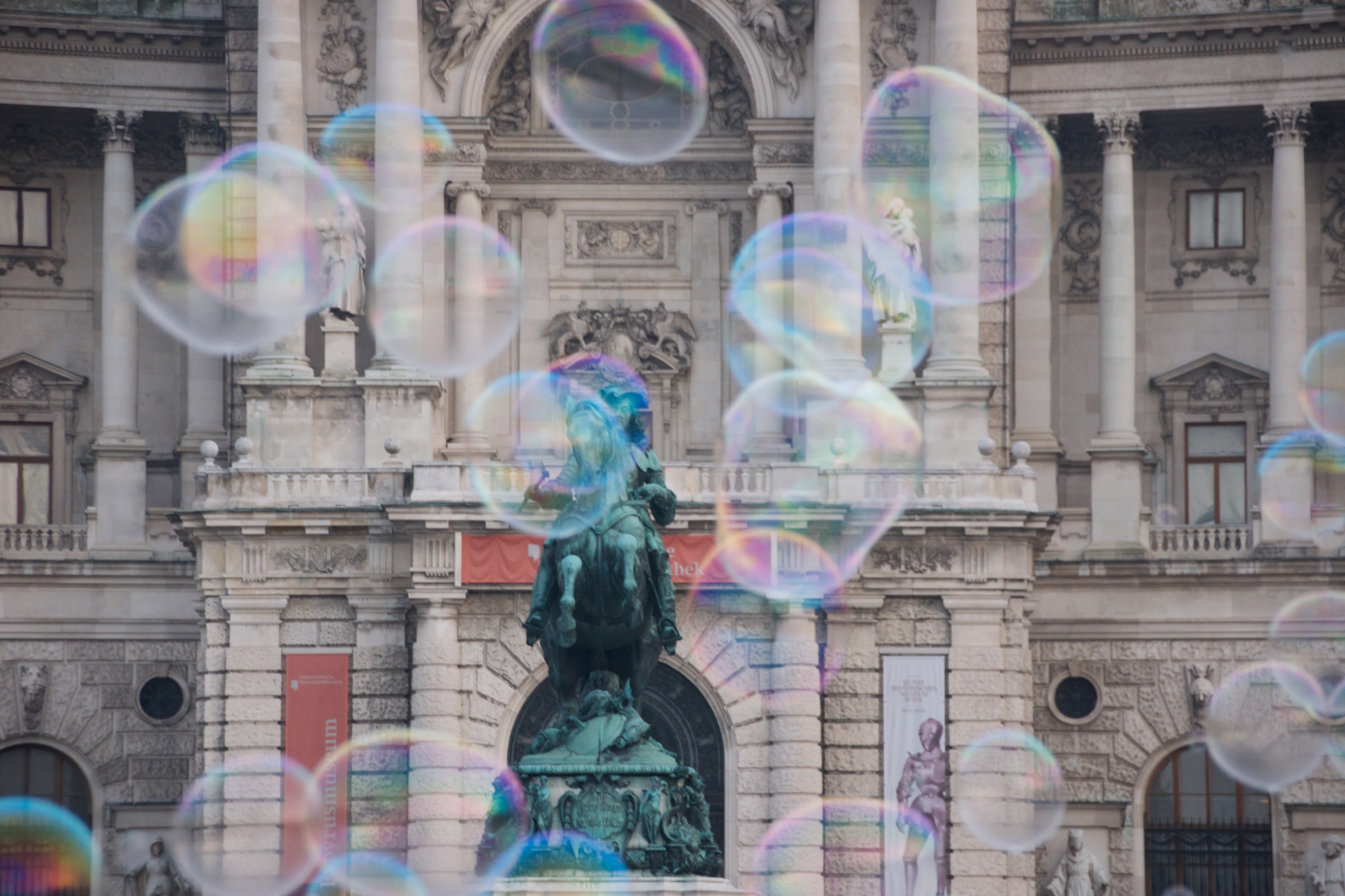 Bubbles in front of a grand building with a statue HD Wallpaper