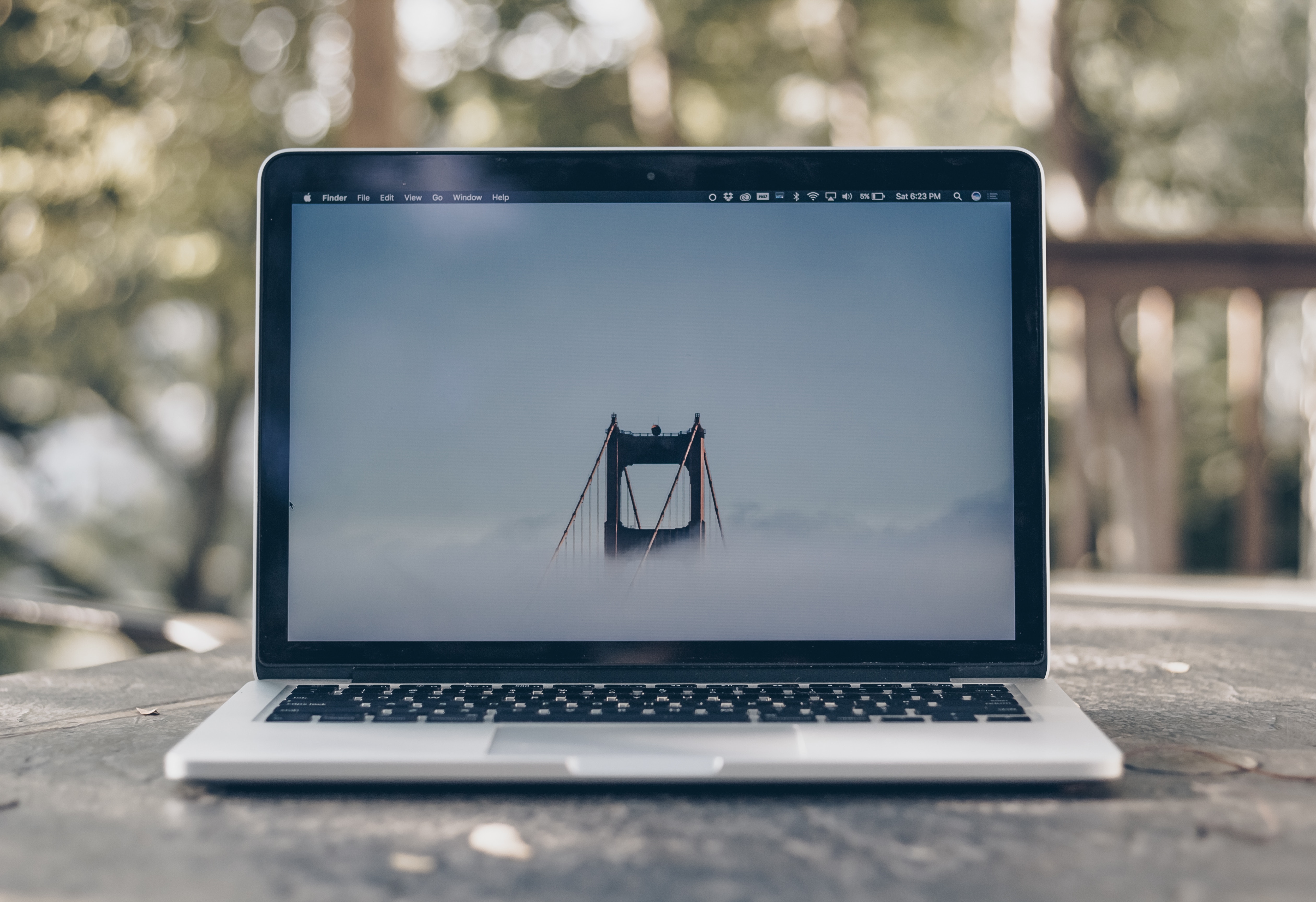 MacBook laptop displaying Golden Gate Bridge in fog HD Wallpaper