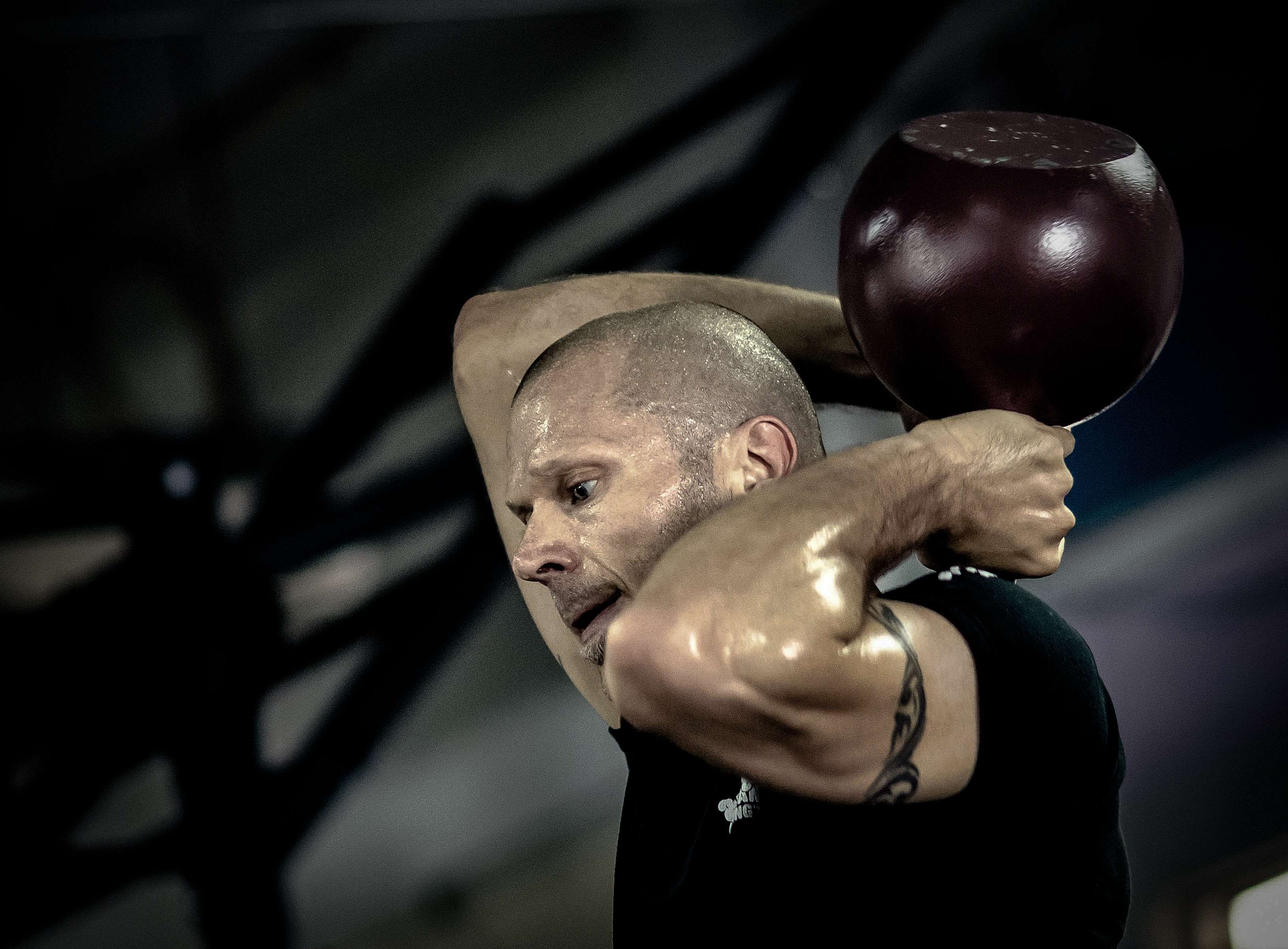 Man performing kettlebell training with a kettlebell HD Wallpaper