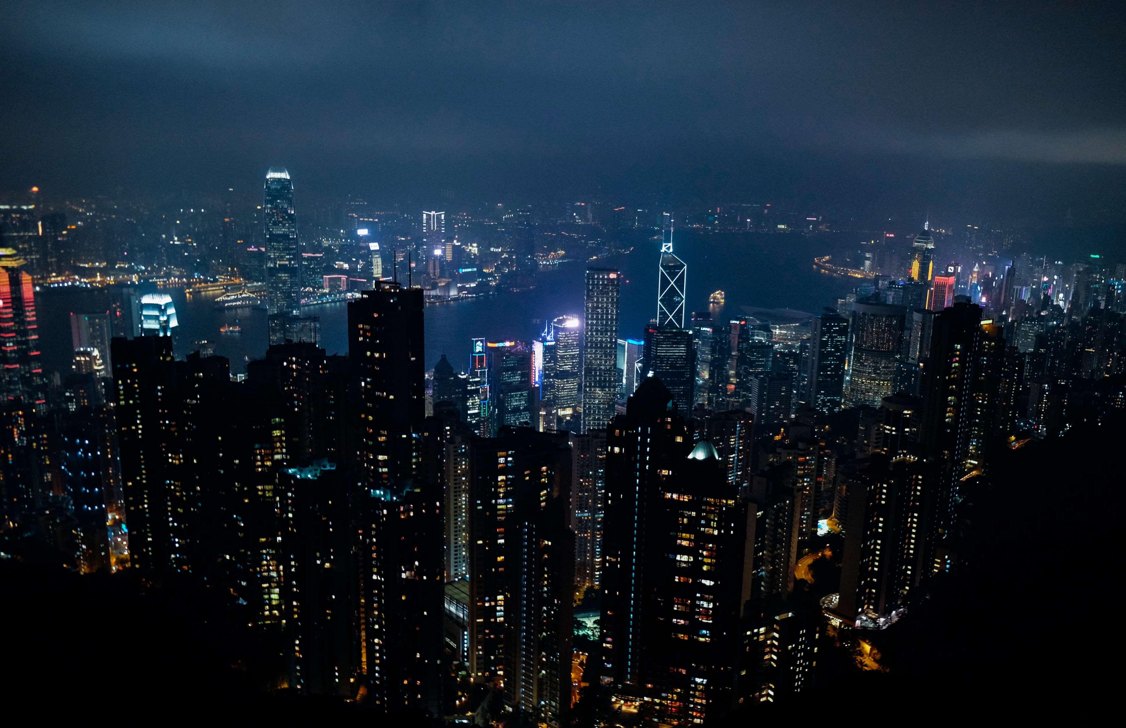 Hong Kong cityscape at night with illuminated skyscrapers HD Wallpaper