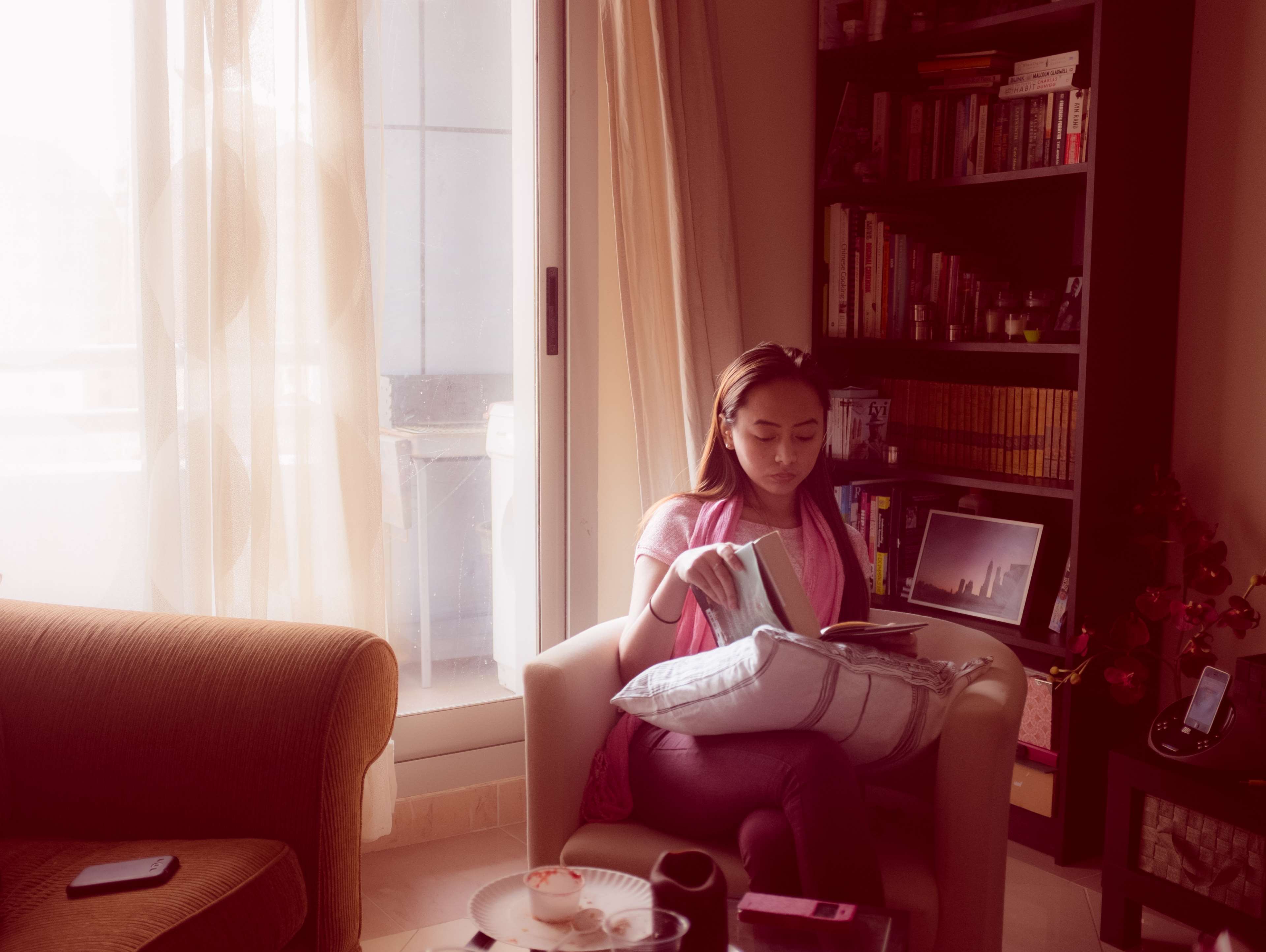 Woman reading a book in a living room HD Wallpaper