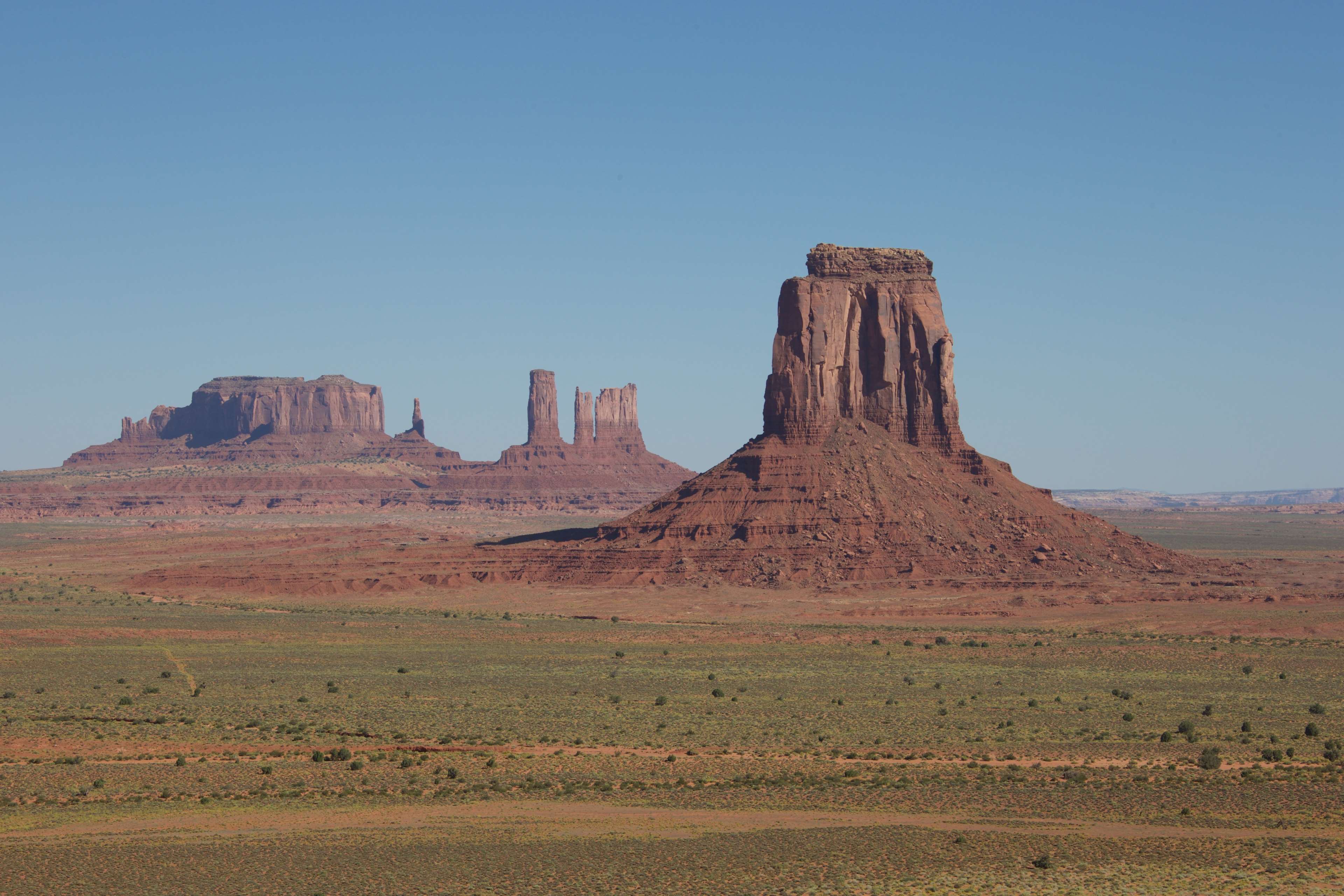 Monument Valley landscape with rock formations and desert HD Wallpaper