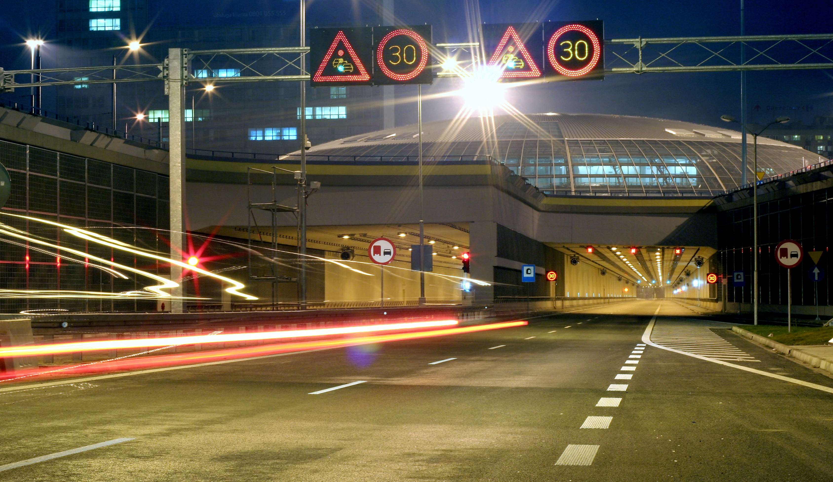 Night view of a tunnel entrance with speed limit signs HD Wallpaper