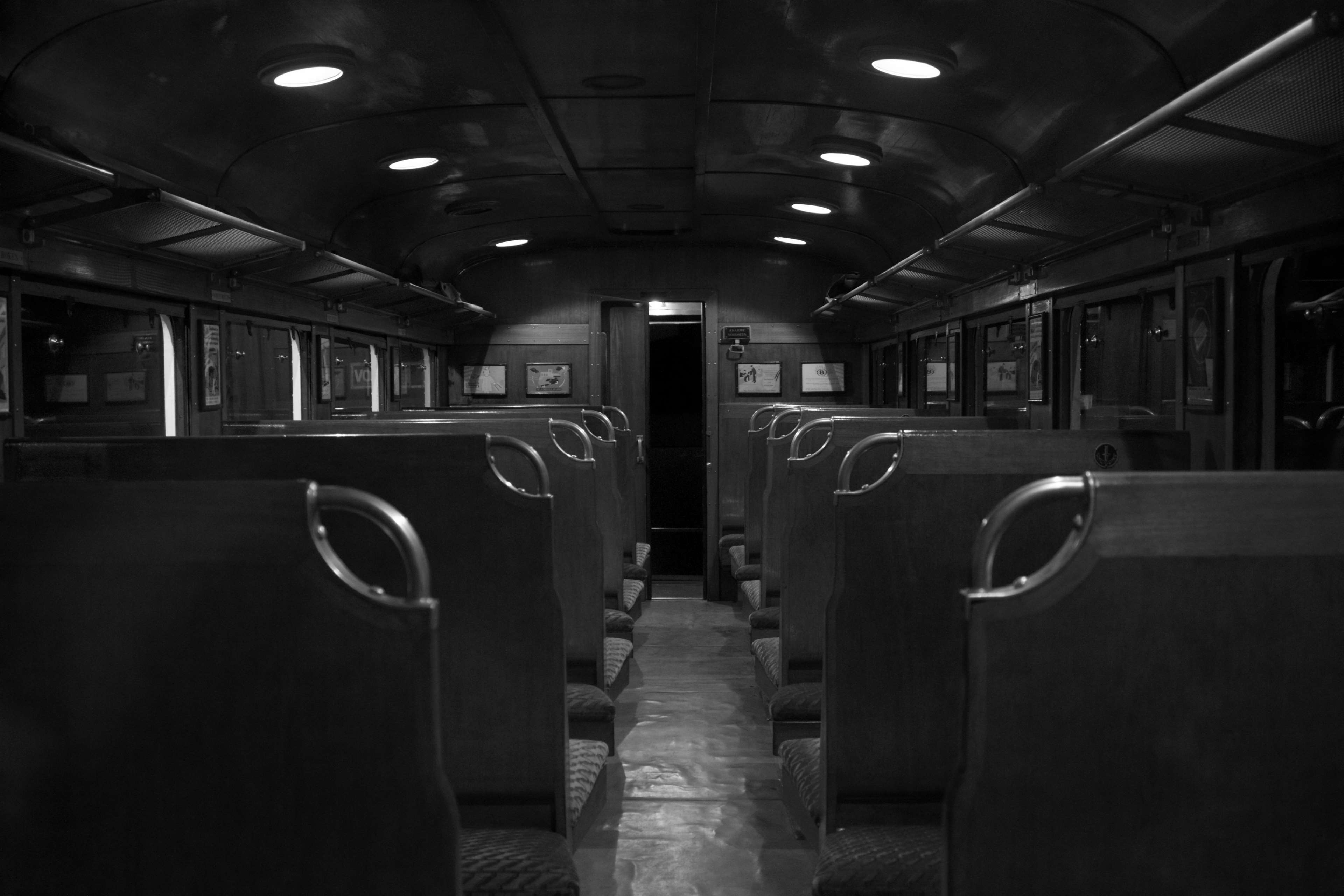 Empty train interior with seats and lights 4K HD Wallpaper