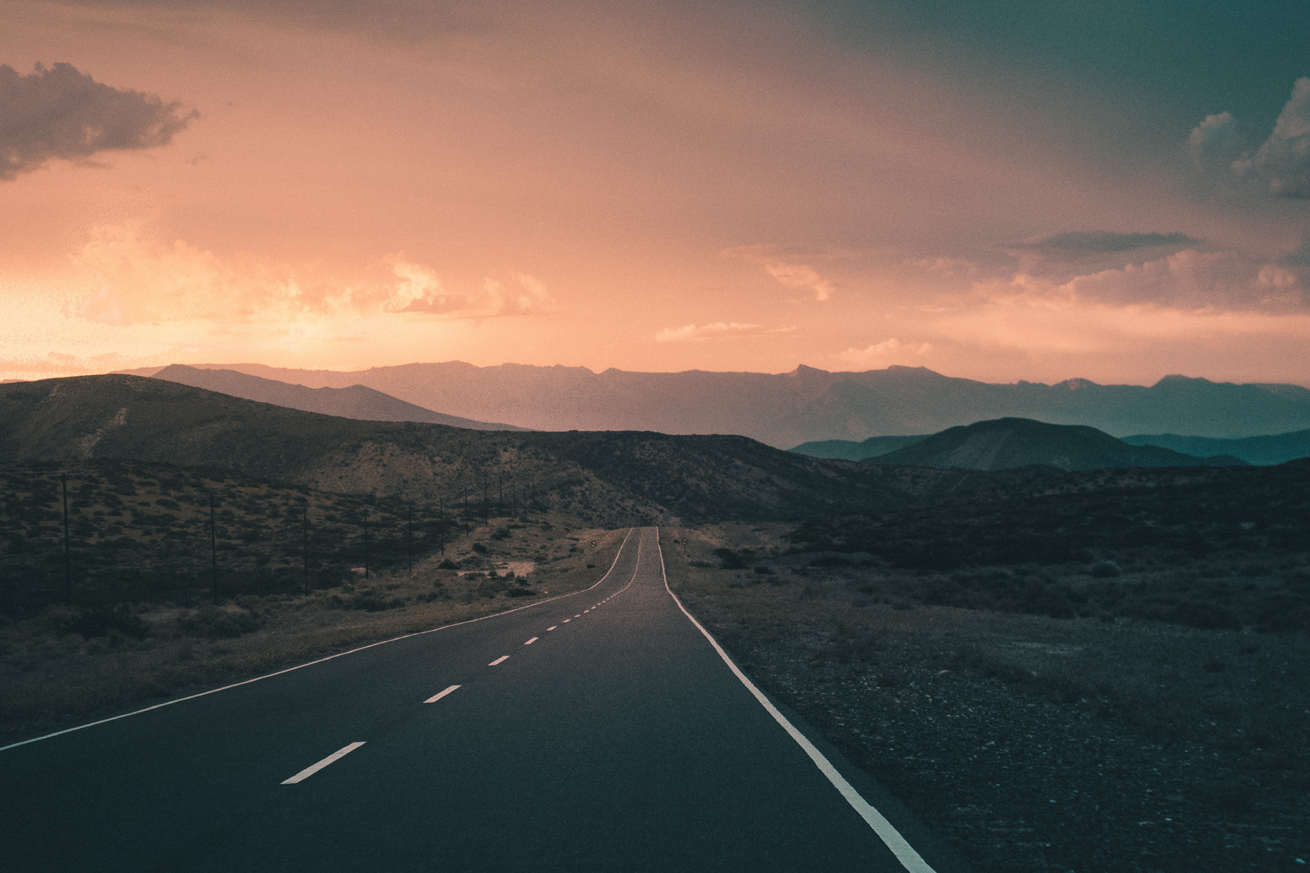 Road through mountains at sunset HD Wallpaper