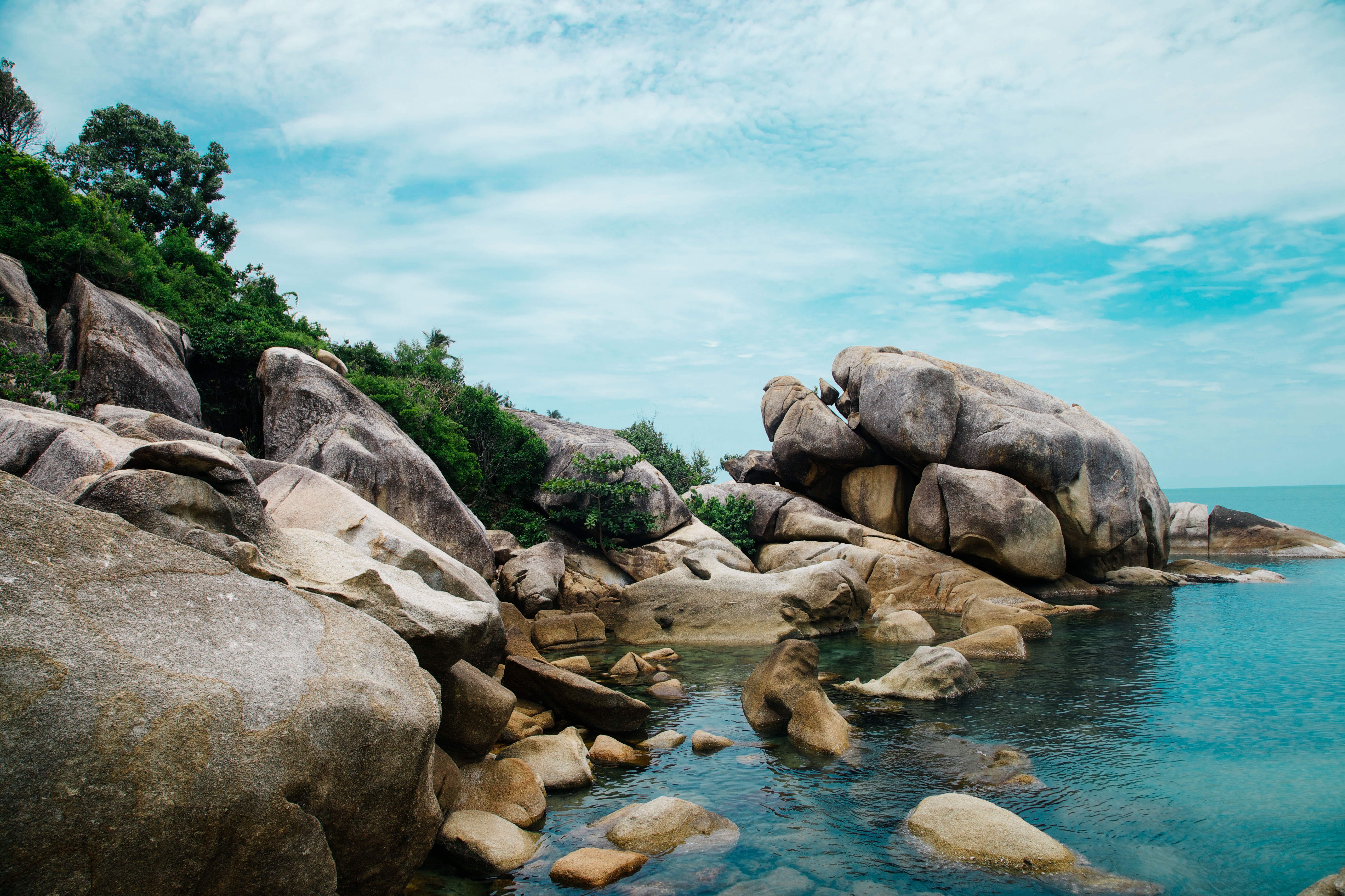 Rocky Coastline with Turquoise Water and Blue Sky HD Wallpaper