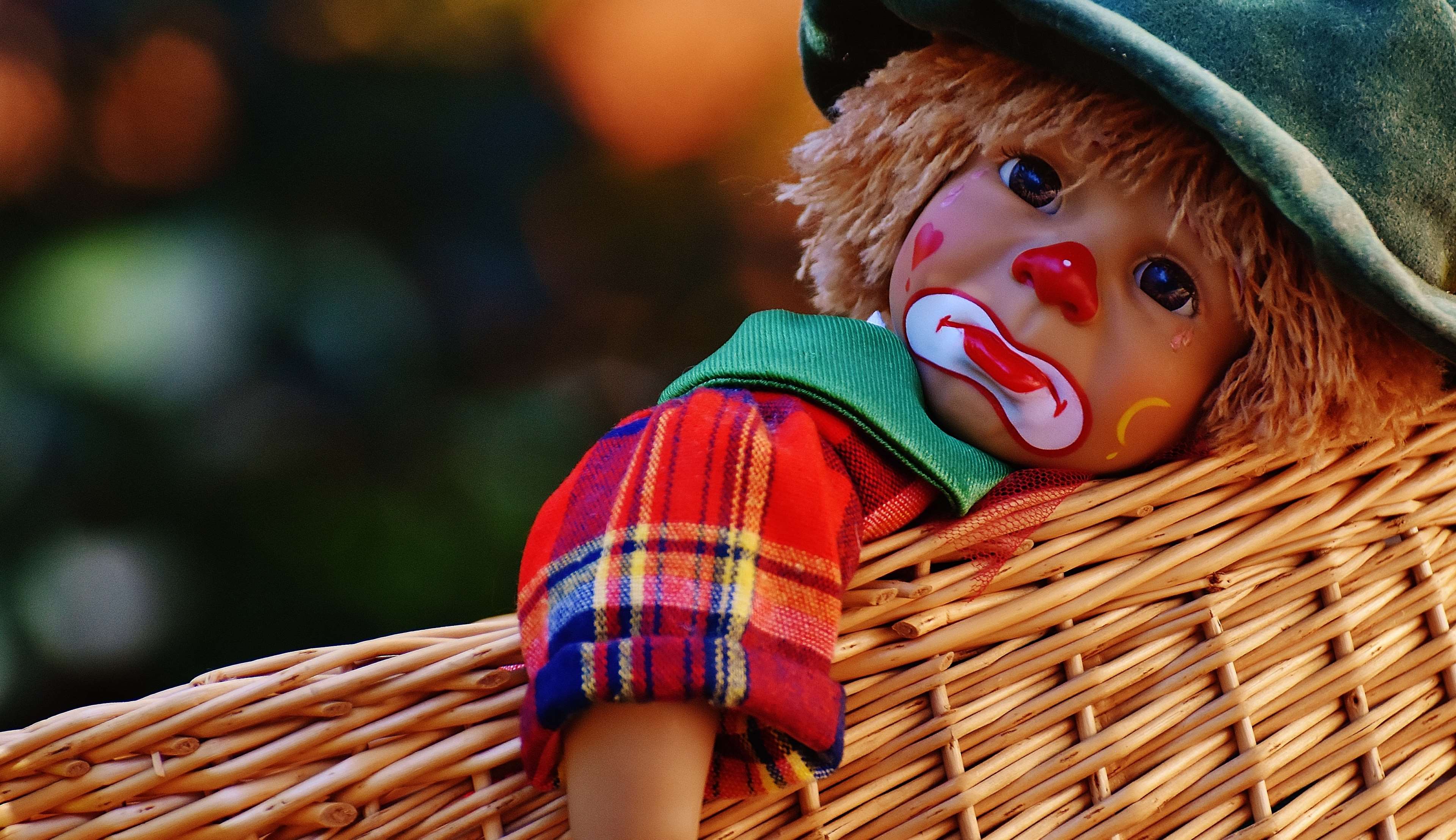 Sad clown doll in a basket HD Wallpaper