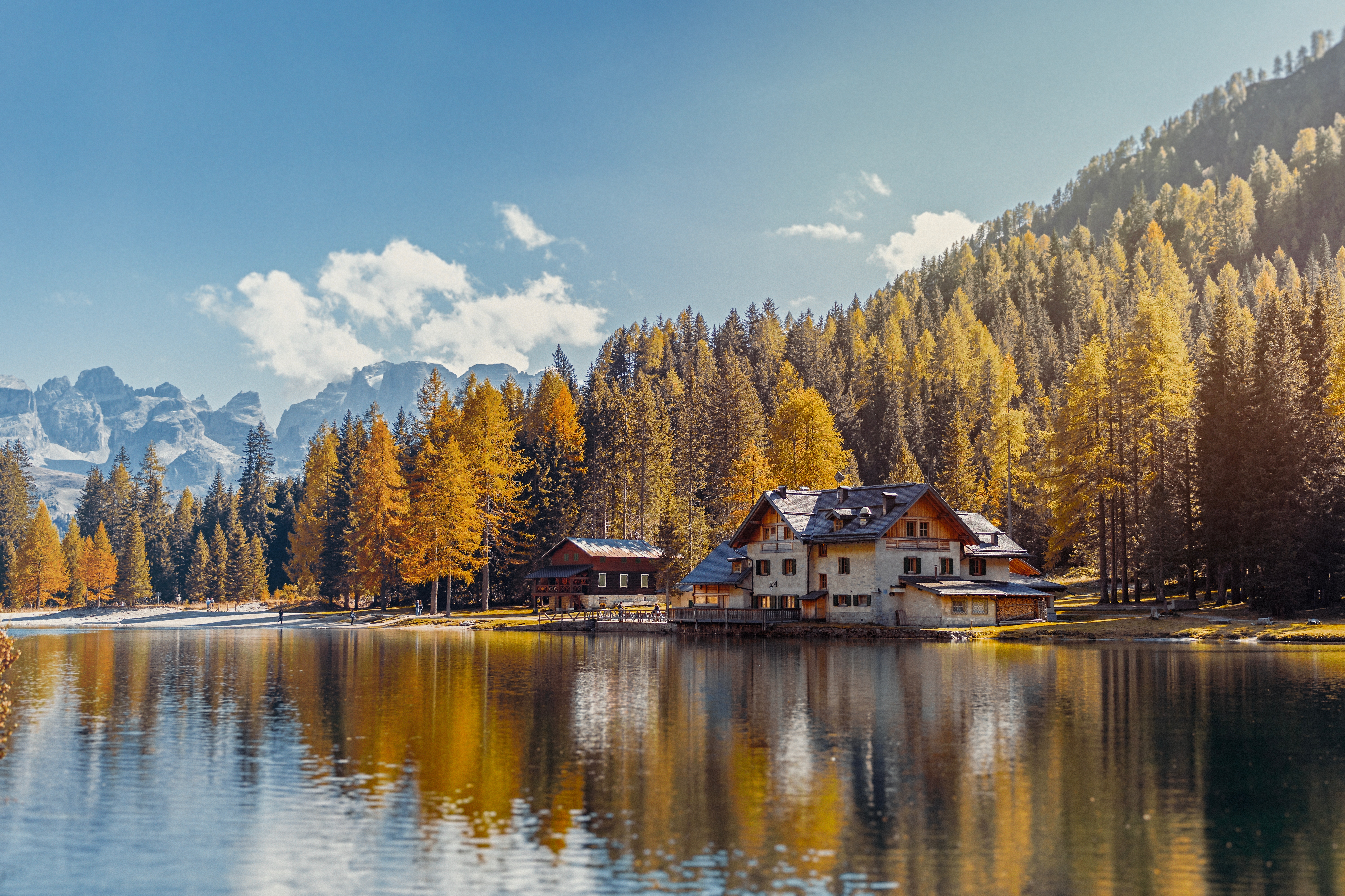 Autumn lake with houses and mountains HD Wallpaper