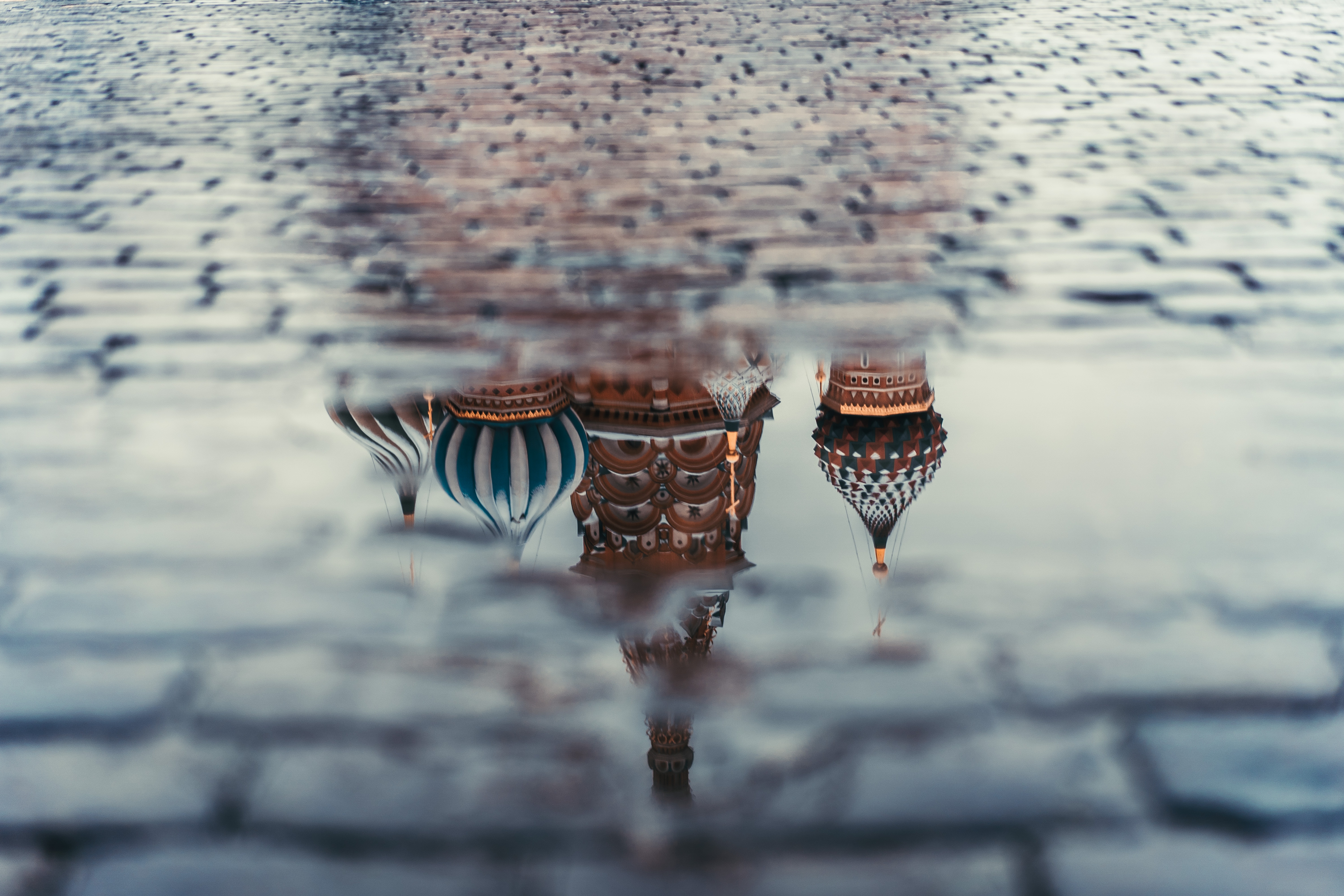 Reflection of St. Basil's Cathedral in a puddle on Red Square, Russia HD Wallpaper