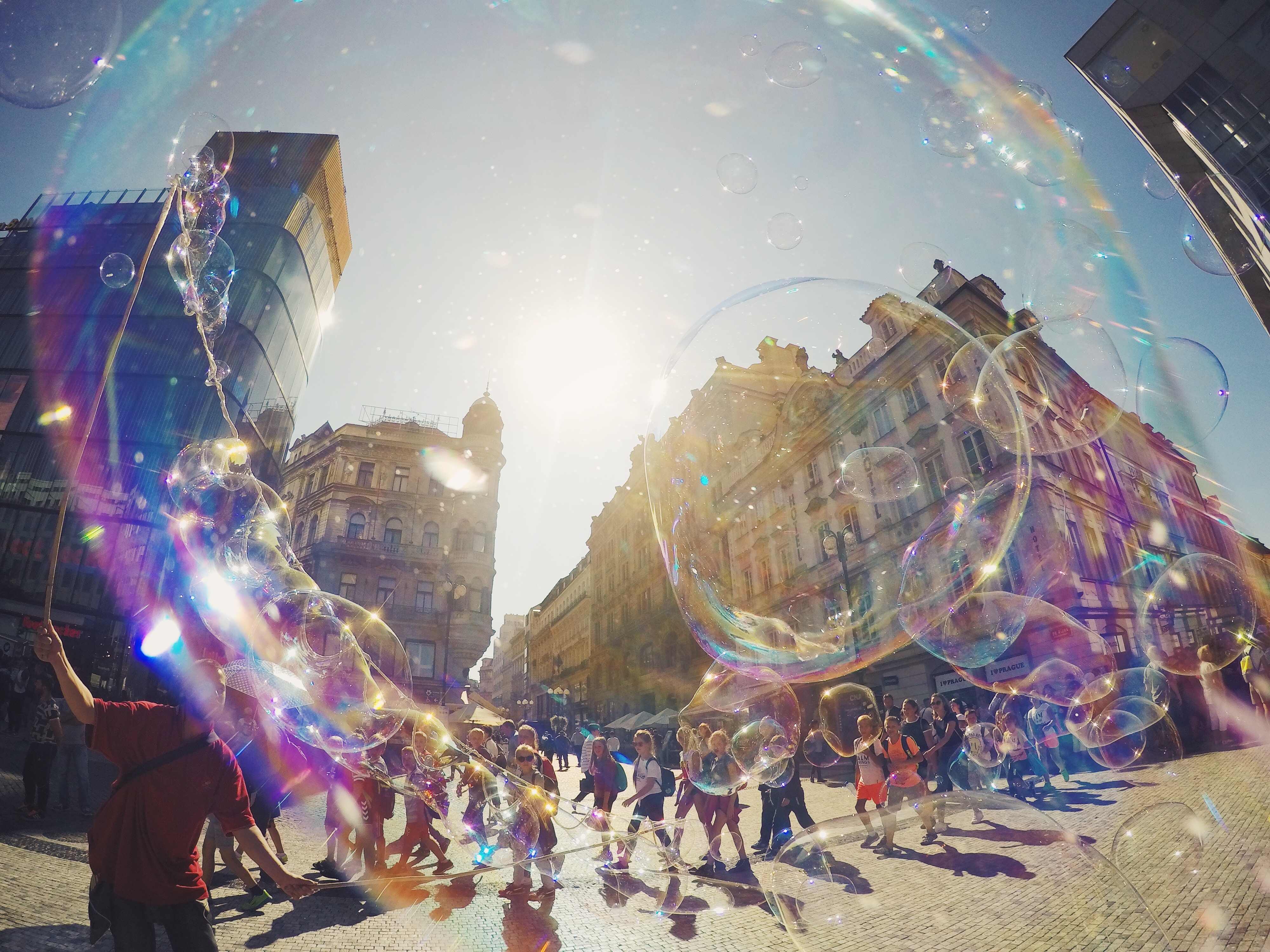 Street performer blowing giant soap bubbles HD Wallpaper
