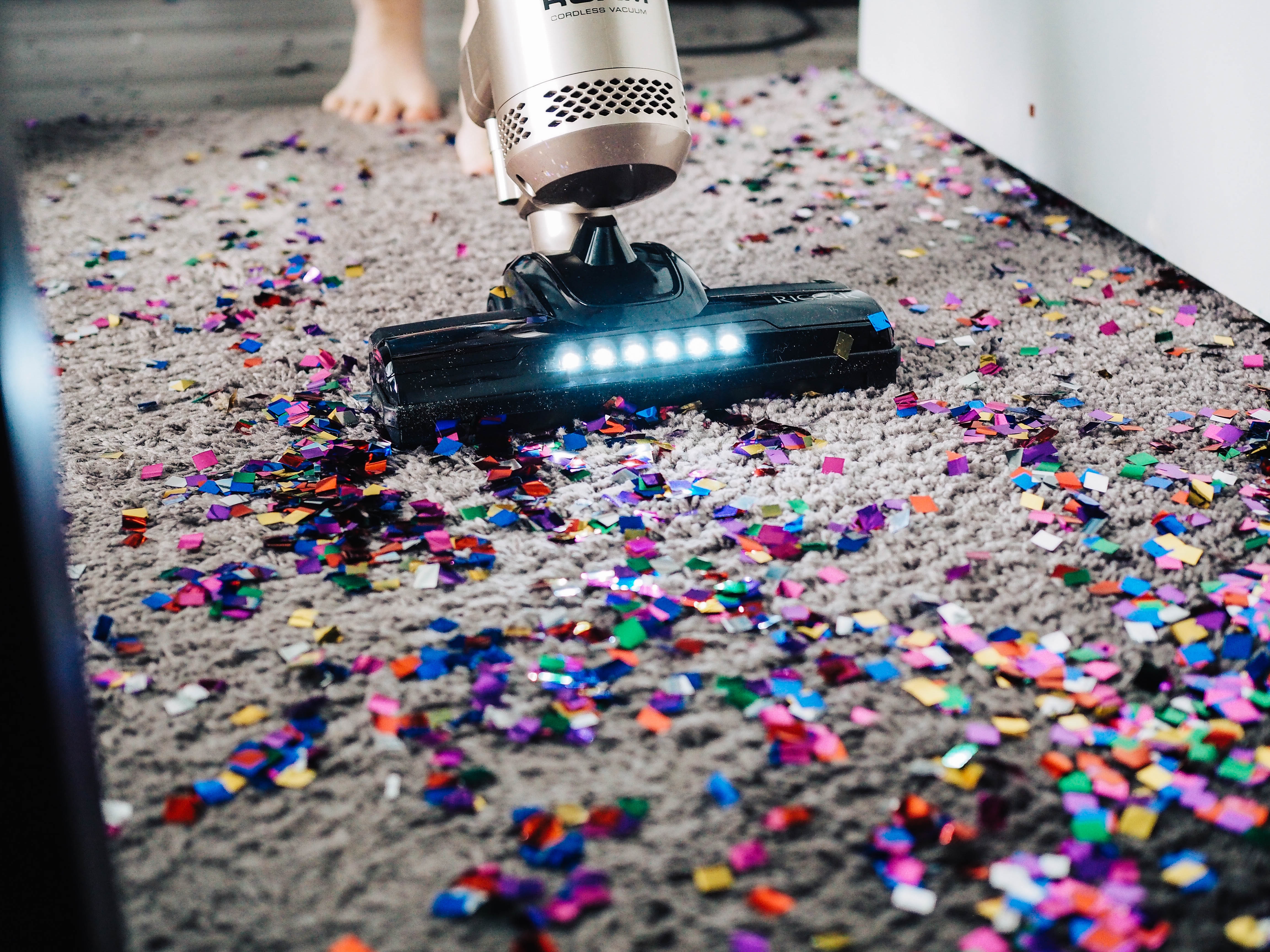 Vacuum cleaning confetti from a carpet HD Wallpaper