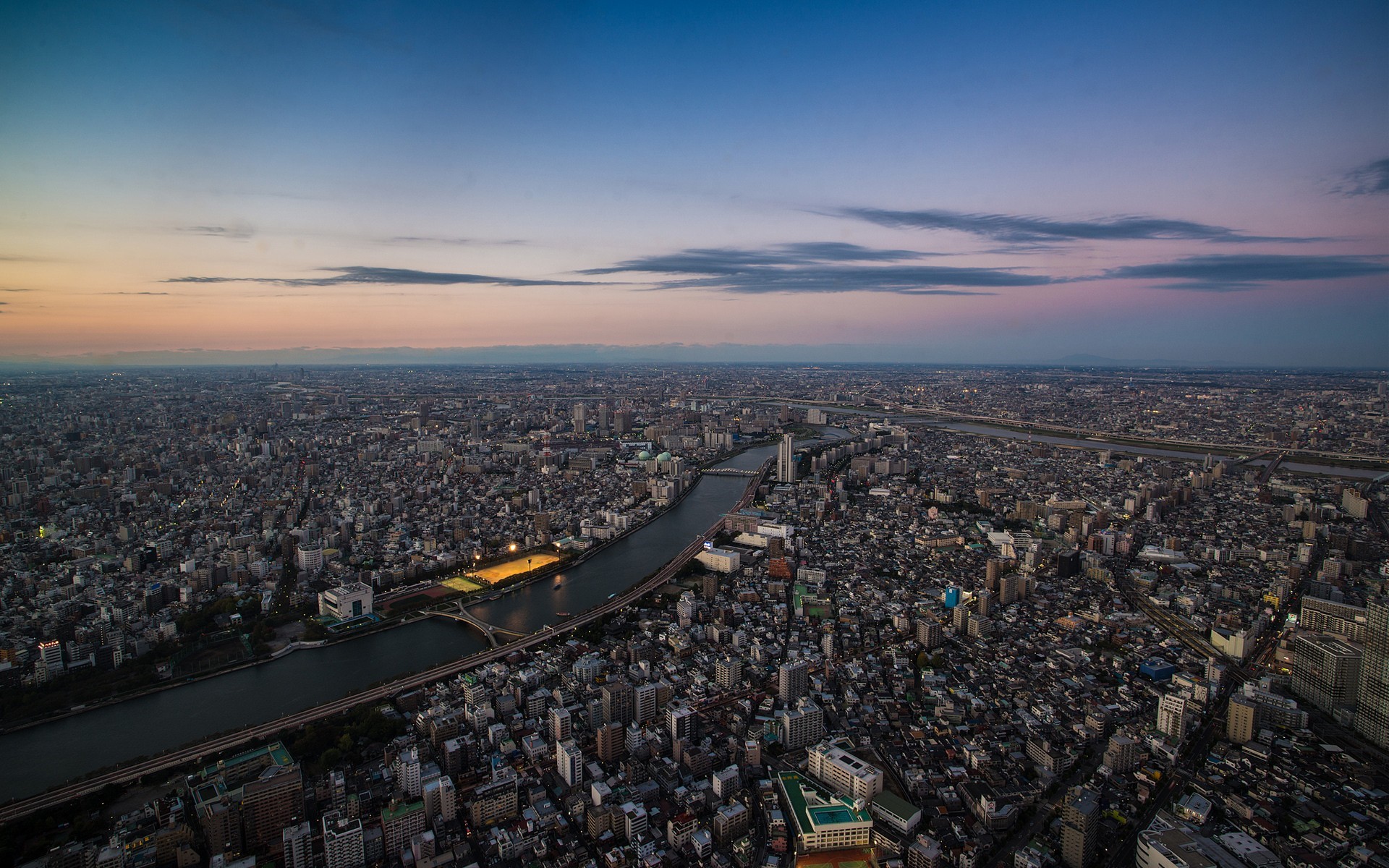 Aerial view of Tokyo cityscape at dusk with Sumida River HD Wallpaper