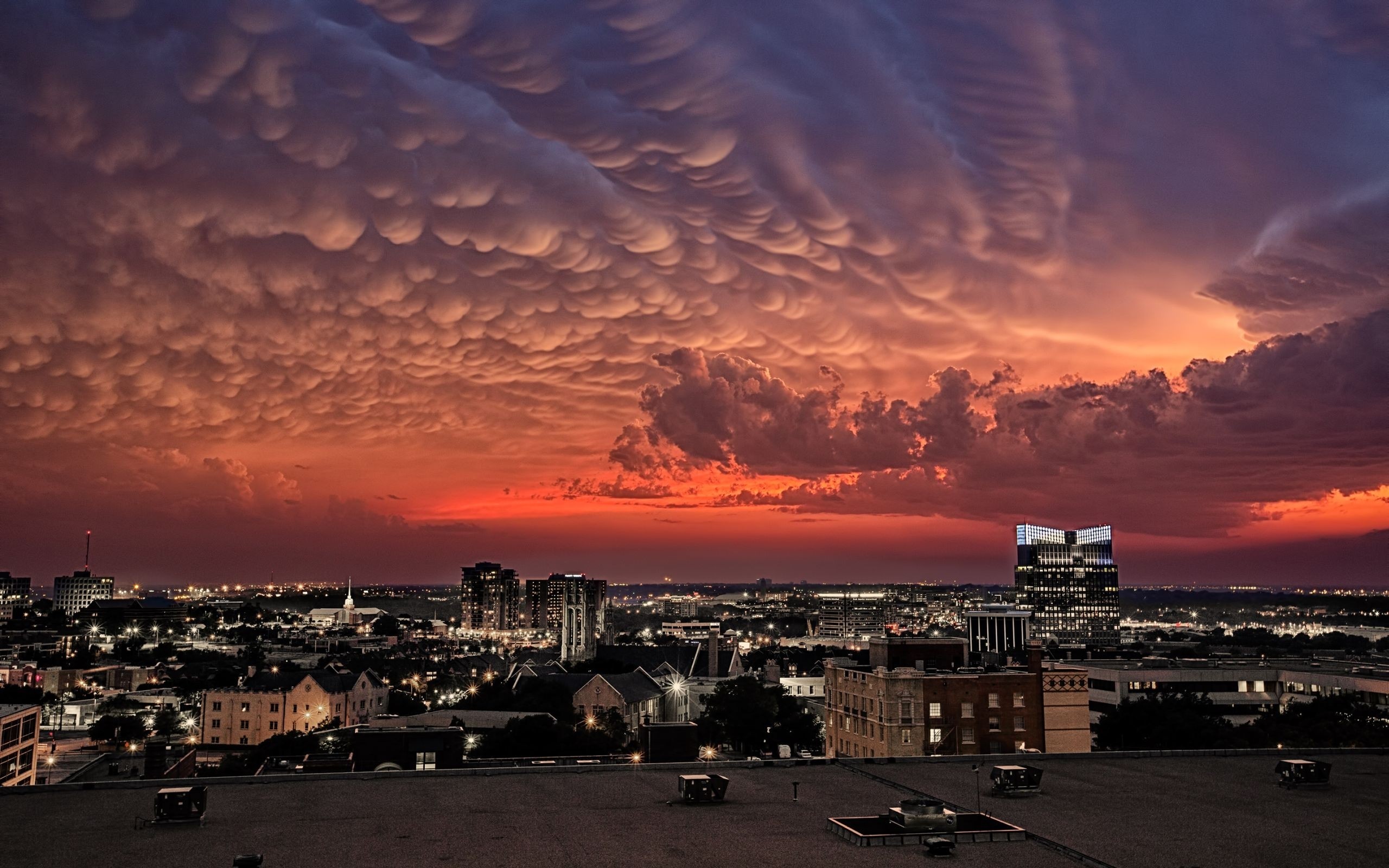 Mammatus clouds over a city at sunset HD Wallpaper