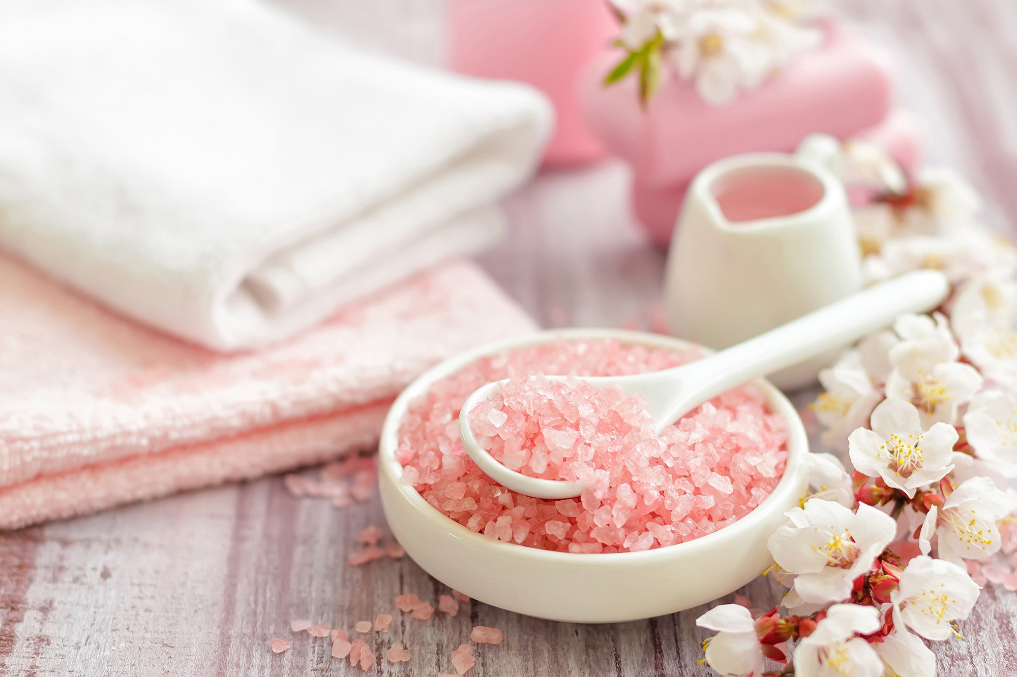 Pink bath salts with flowers and towels HD Wallpaper