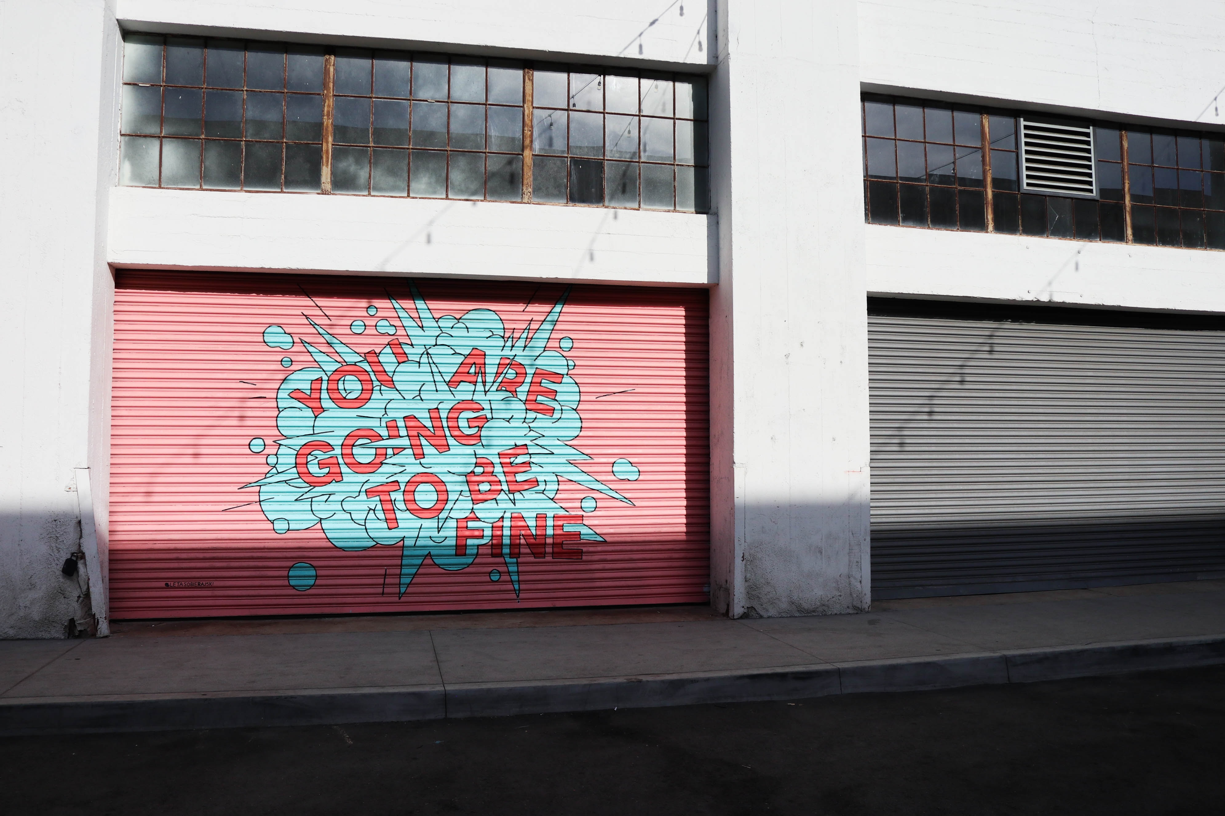 Mural on a pink garage door: "You are going to be fine" HD Wallpaper