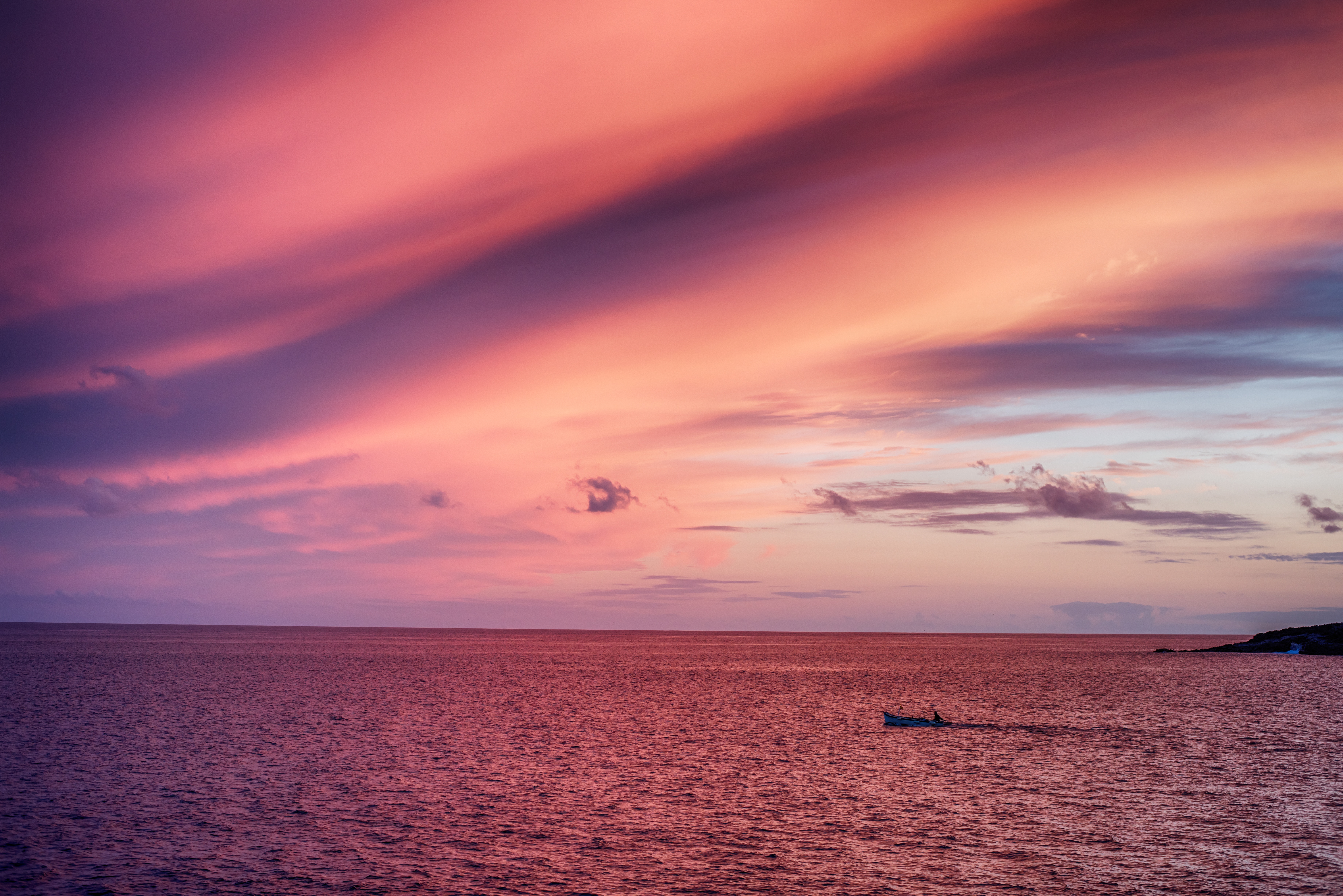 Boat on the sea during a colorful sunset HD Wallpaper
