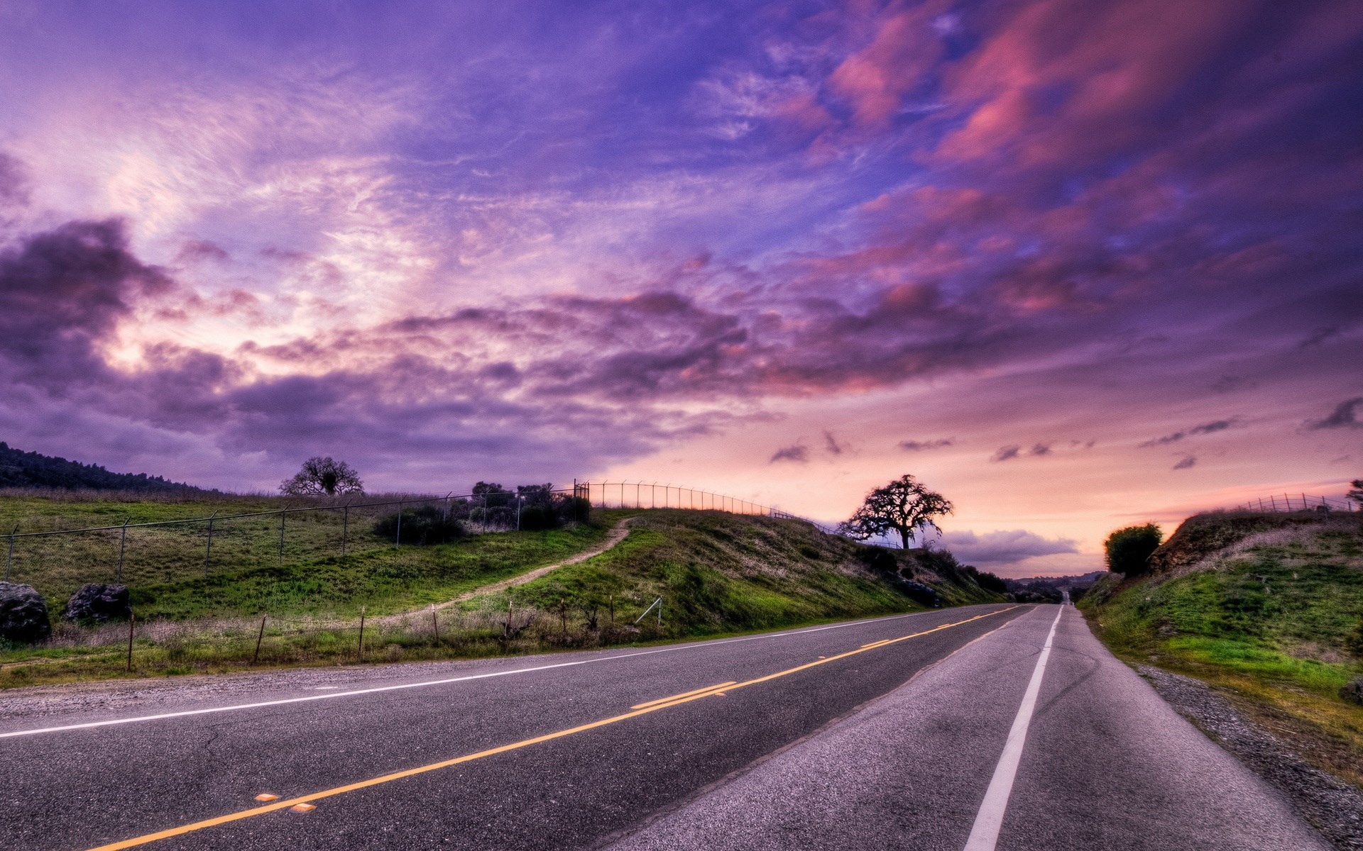 Road through rolling hills at sunset HD Wallpaper