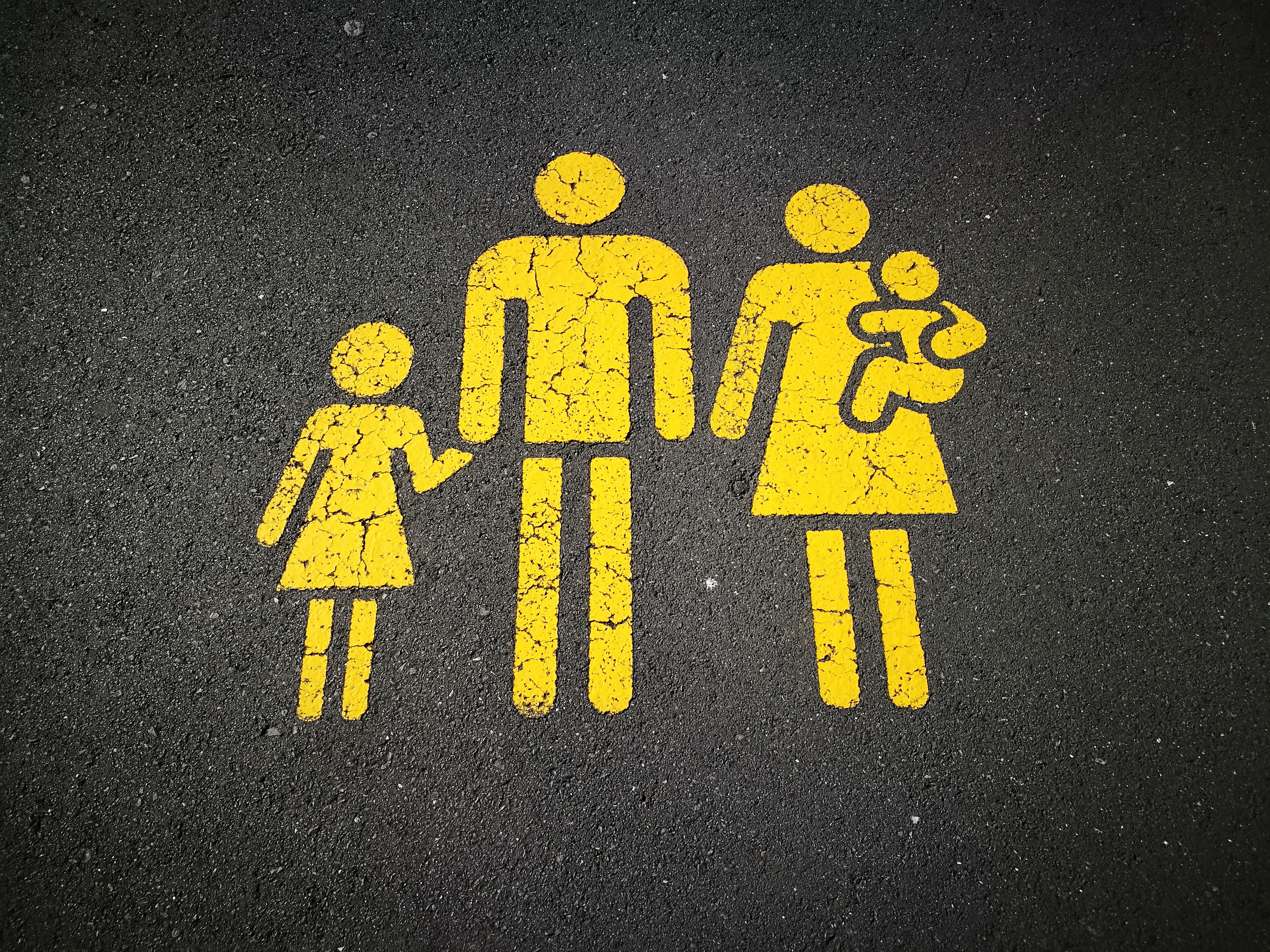 Yellow family icon painted on asphalt HD Wallpaper