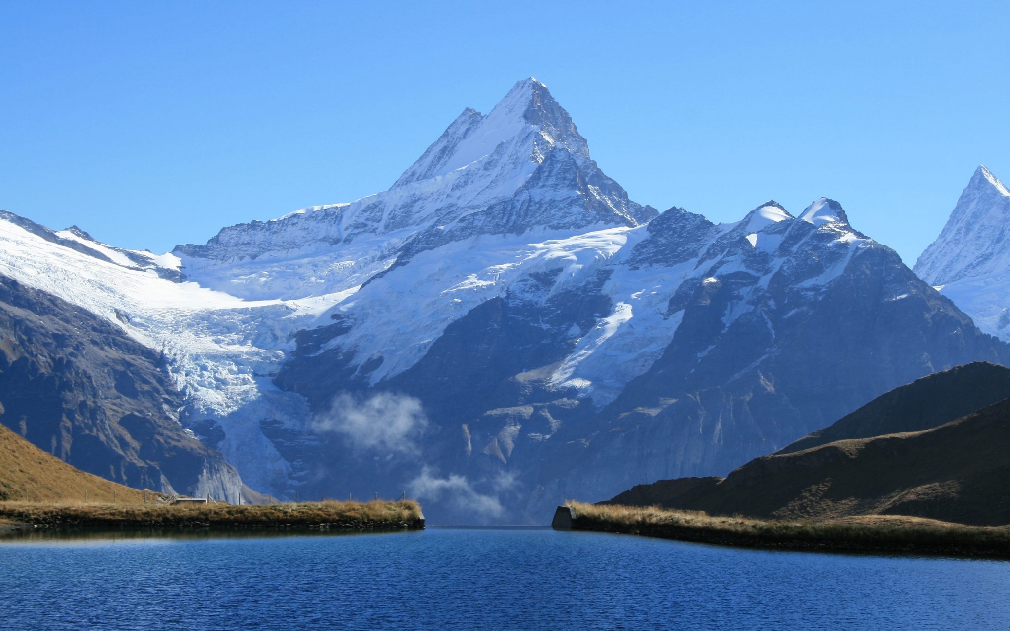 Snow-capped mountains reflected in a lake HD Wallpaper