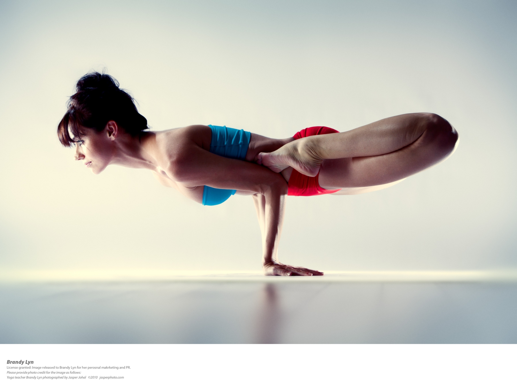 Woman performing yoga pose on hands HD Wallpaper