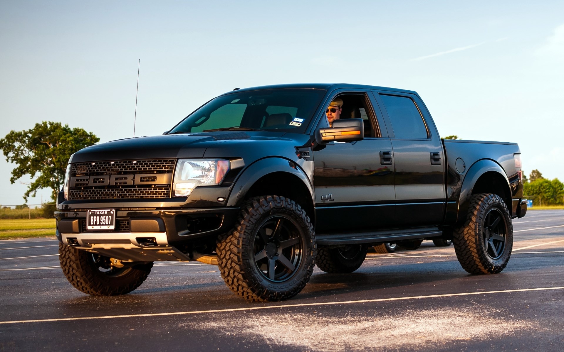 Black Ford F-150 Raptor Truck with Driver HD Wallpaper