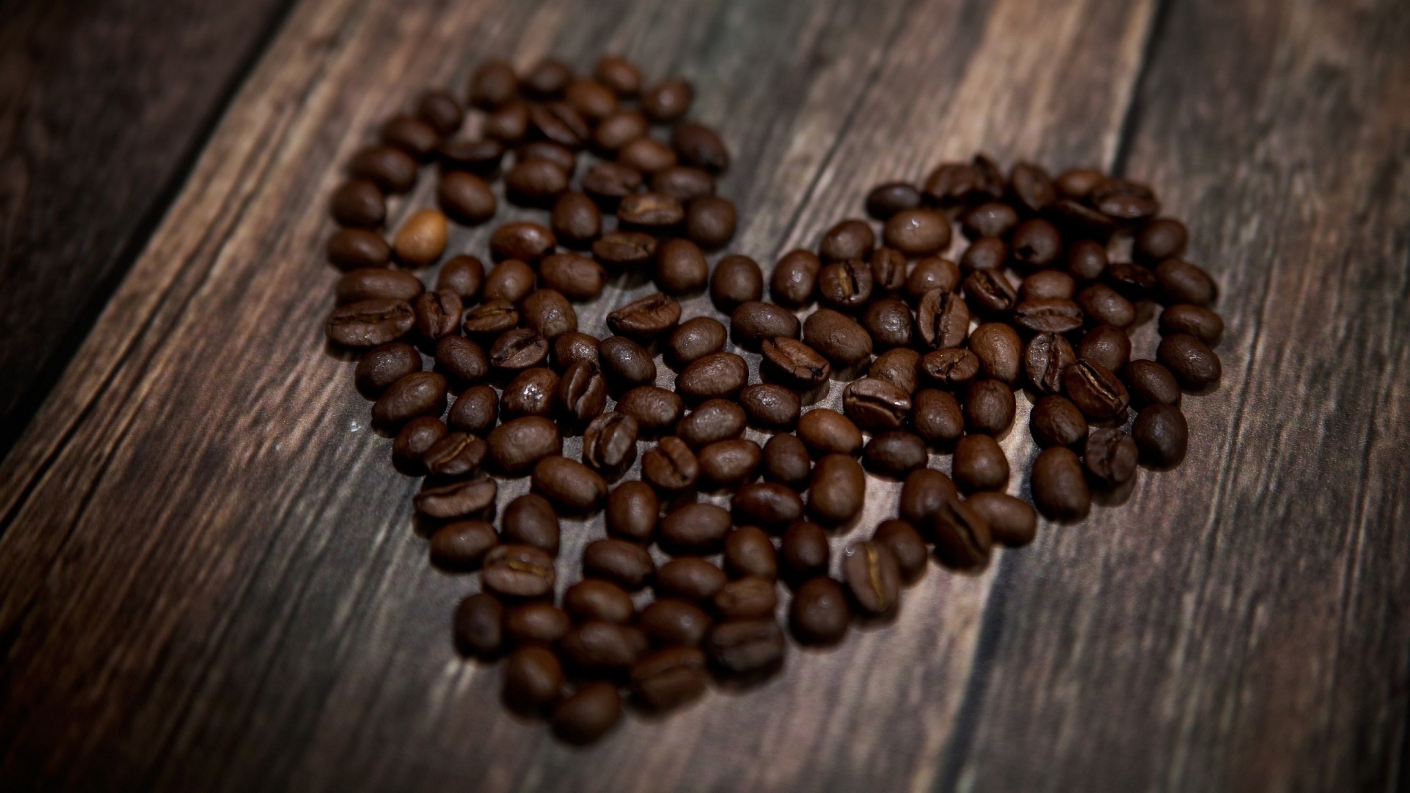 Heart shape made of coffee beans on wooden background HD Wallpaper