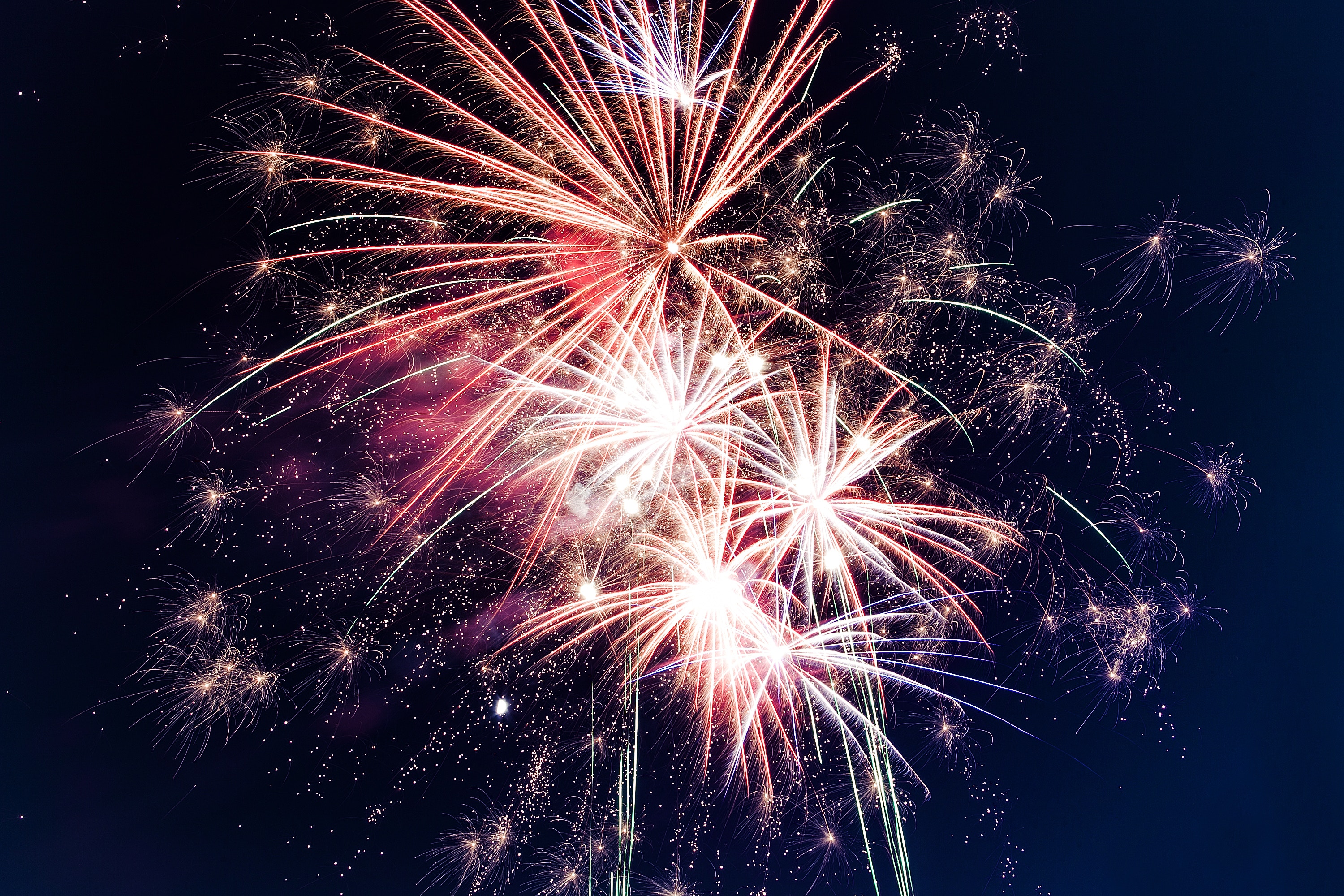 Fireworks exploding in the night sky HD Wallpaper