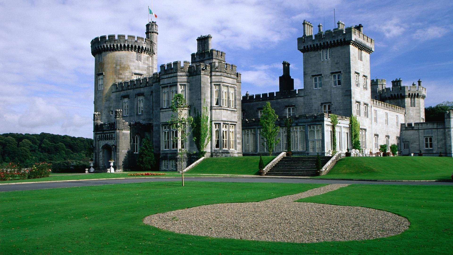 Castle with a flag on a hill under a blue sky HD Wallpaper