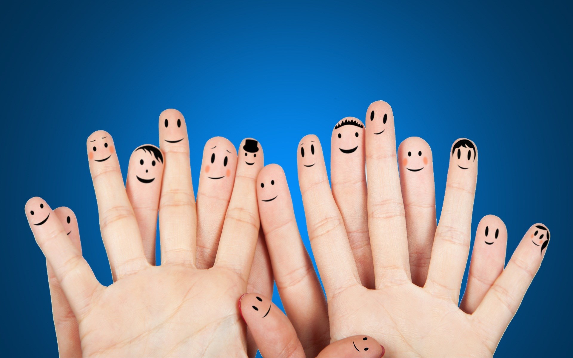Fingers with faces on blue background HD Wallpaper