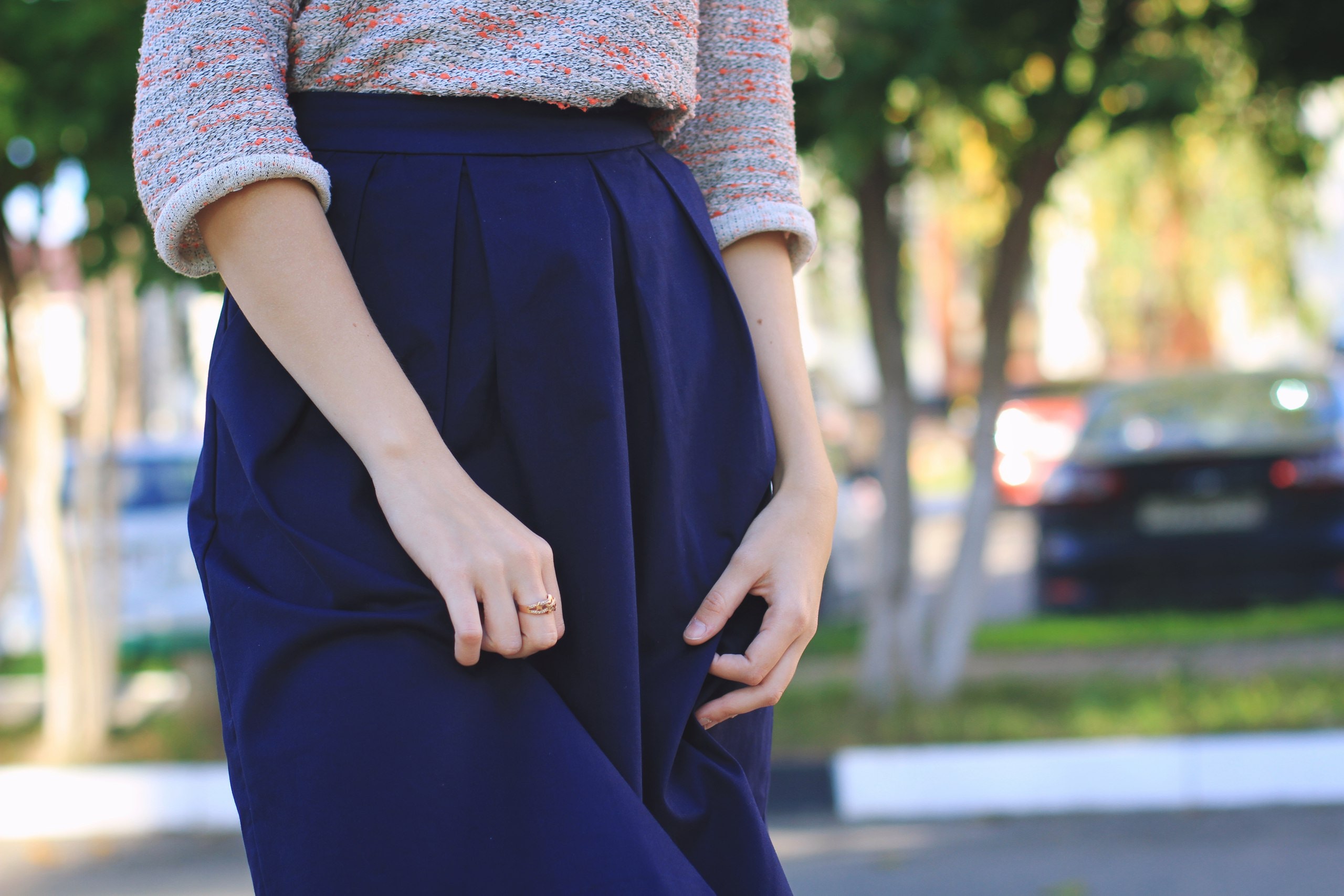 Woman in blue skirt and patterned sweater HD Wallpaper