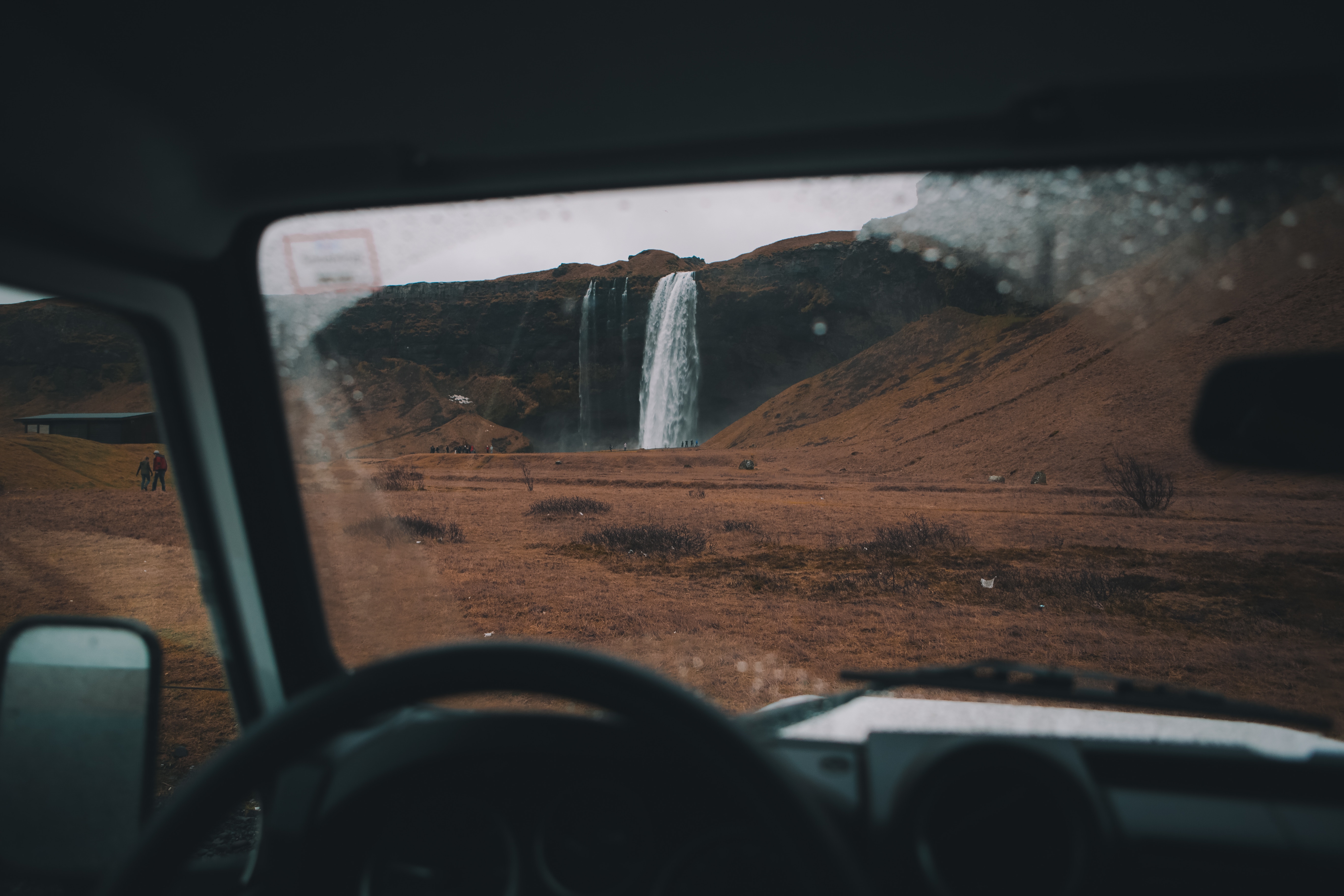 View of Seljalandsfoss waterfall from a Land Rover HD Wallpaper