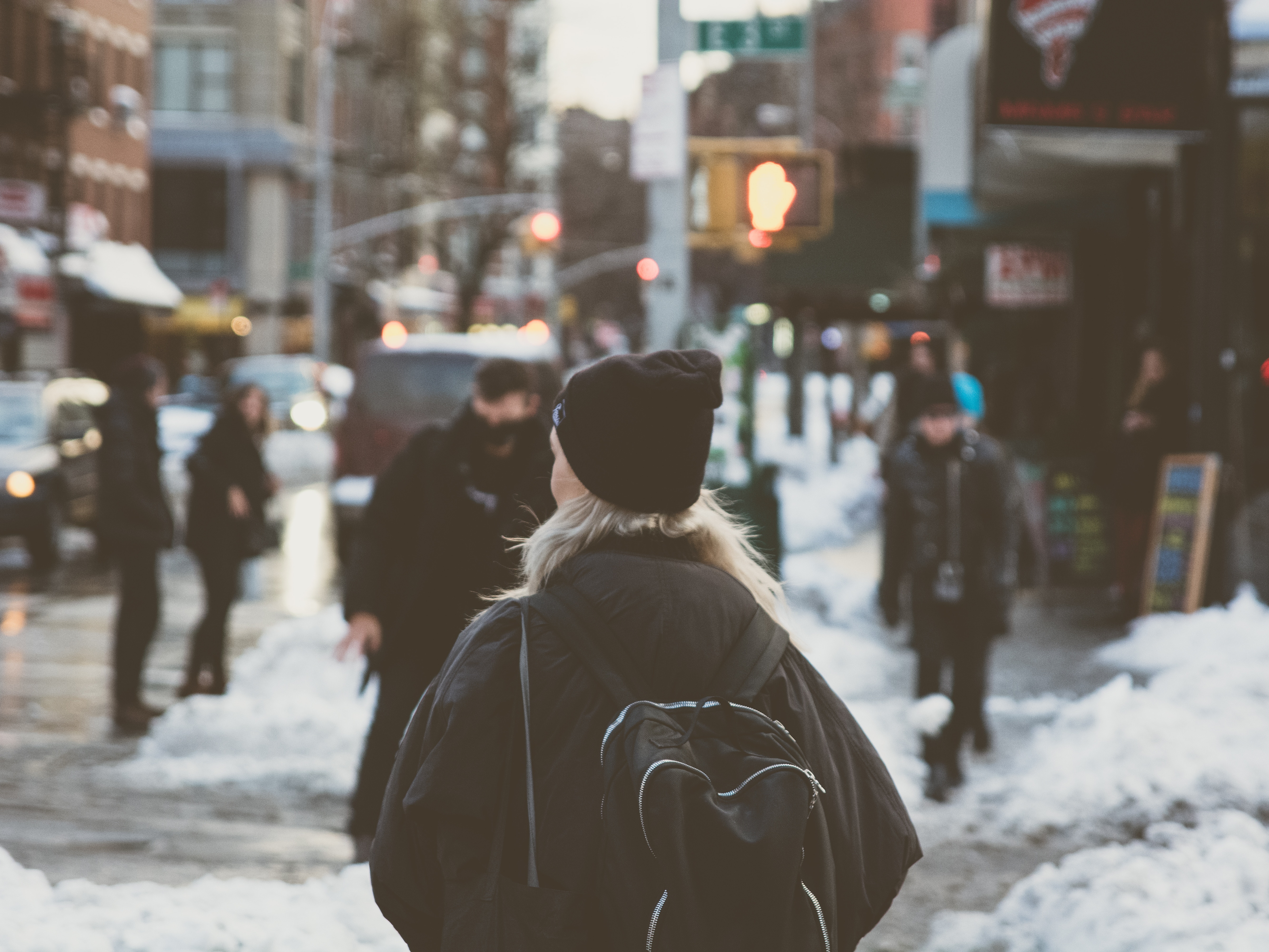 People walking on a snowy street in the East Village HD Wallpaper